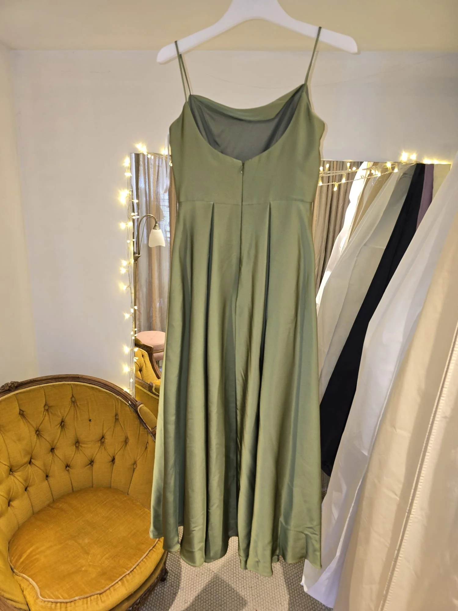 Olive green formal dress with spaghetti straps and pleated skirt, displayed before alterations for a bespoke fit at Brighton Alterations.