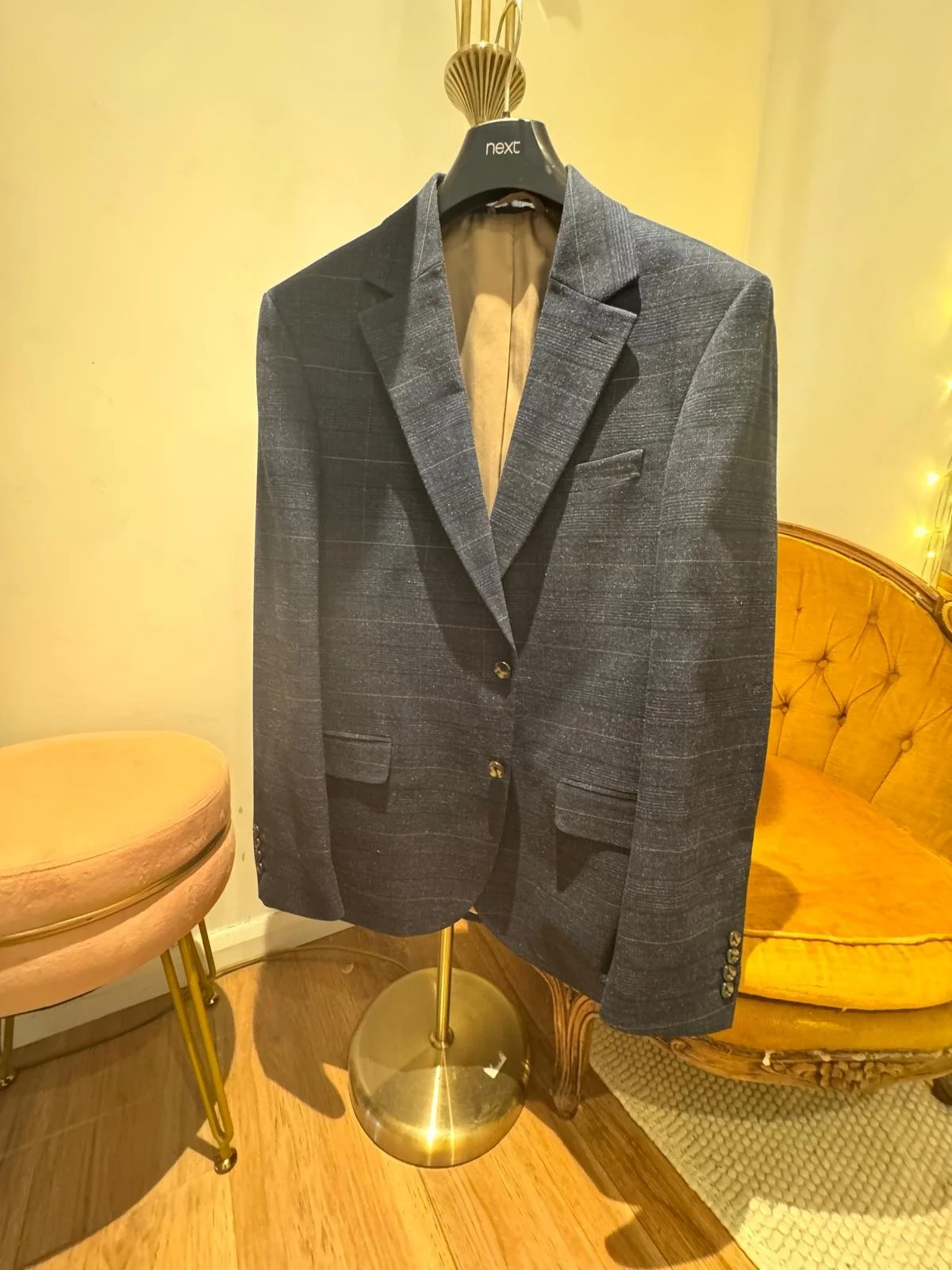 Grey check wool-blend blazer shown pinned and ready for tailoring, with structured shoulders and light check detailing. A modern, versatile layer for weddings, business events, or smart occasions.