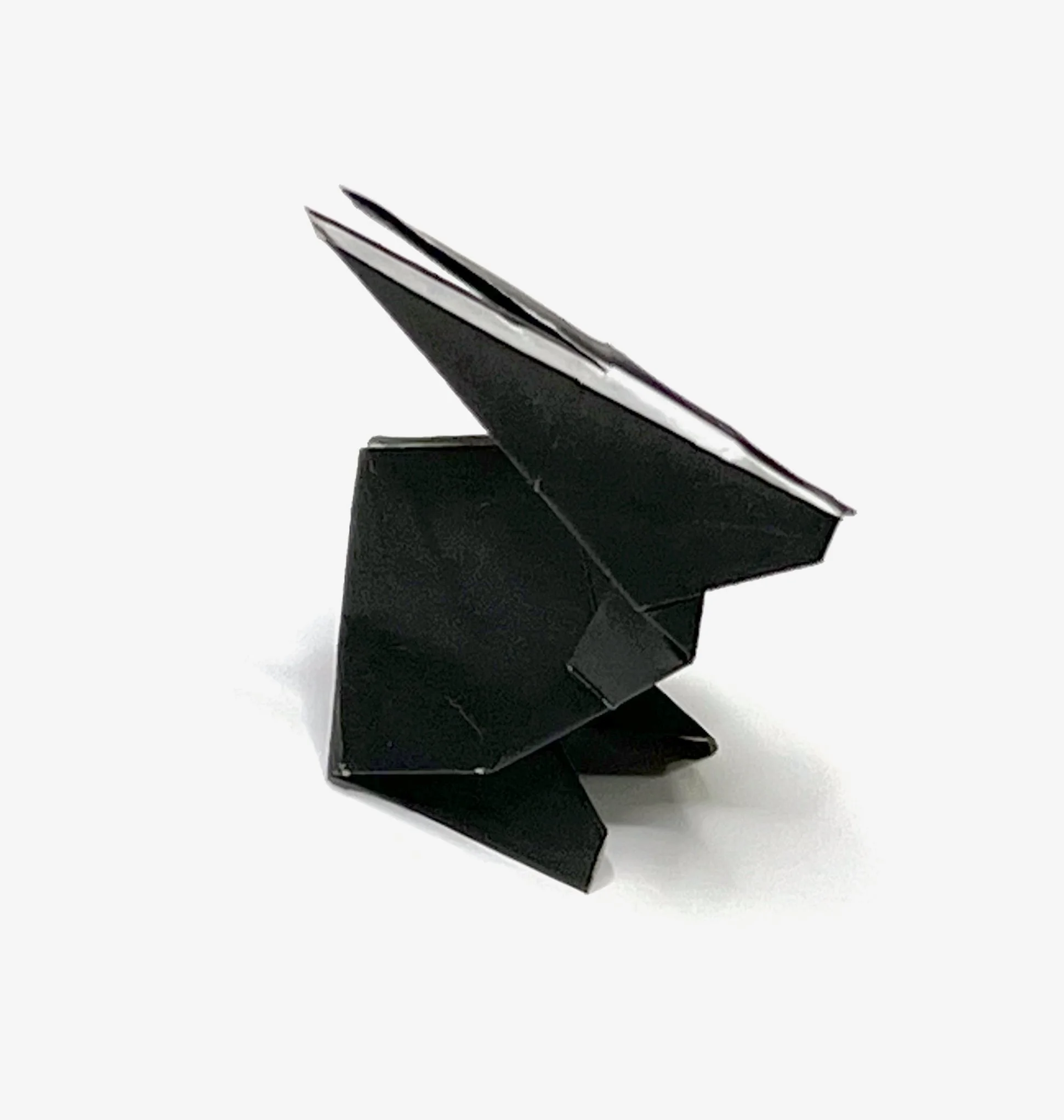 Black origami rabbit against a white background