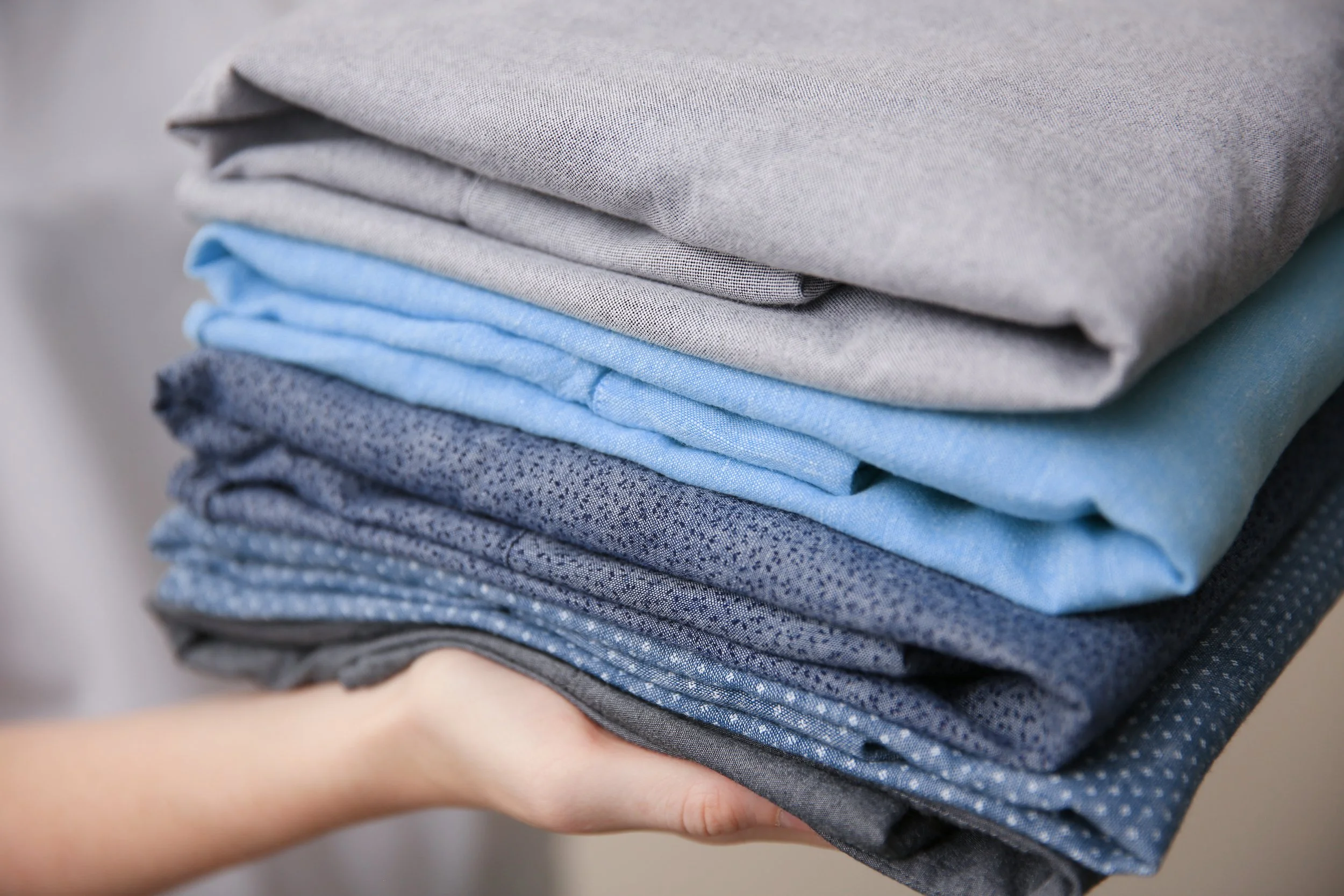 Clean, neatly folded clothes after fluff and fold service.