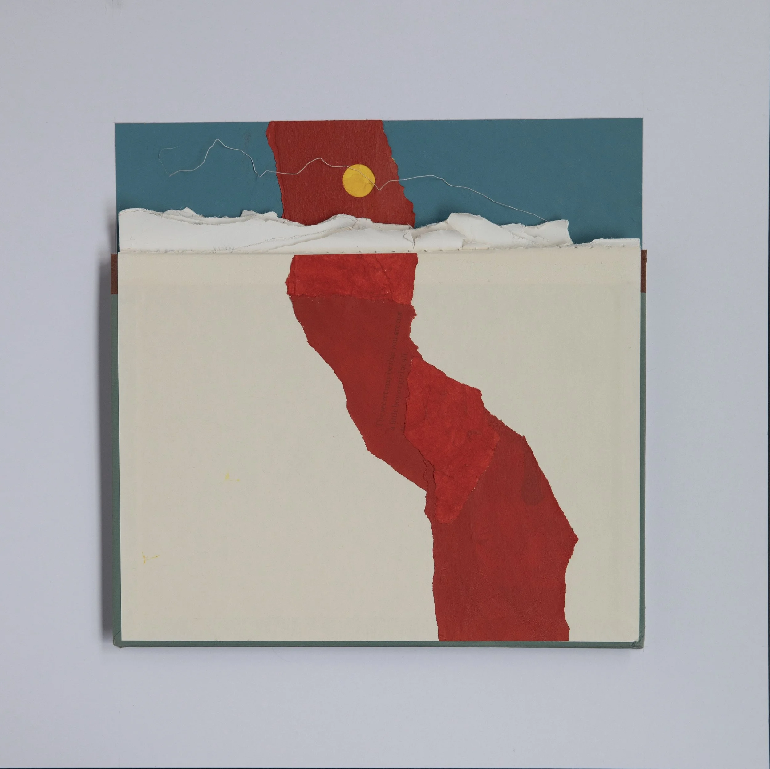 18 by 18 inch mixed media collage with a book cover at center; painted red paper leads to where the book's spine would be. In its place are white paper scraps that look like mountains. Shapes of painted paper suggest a sun setting on the land.