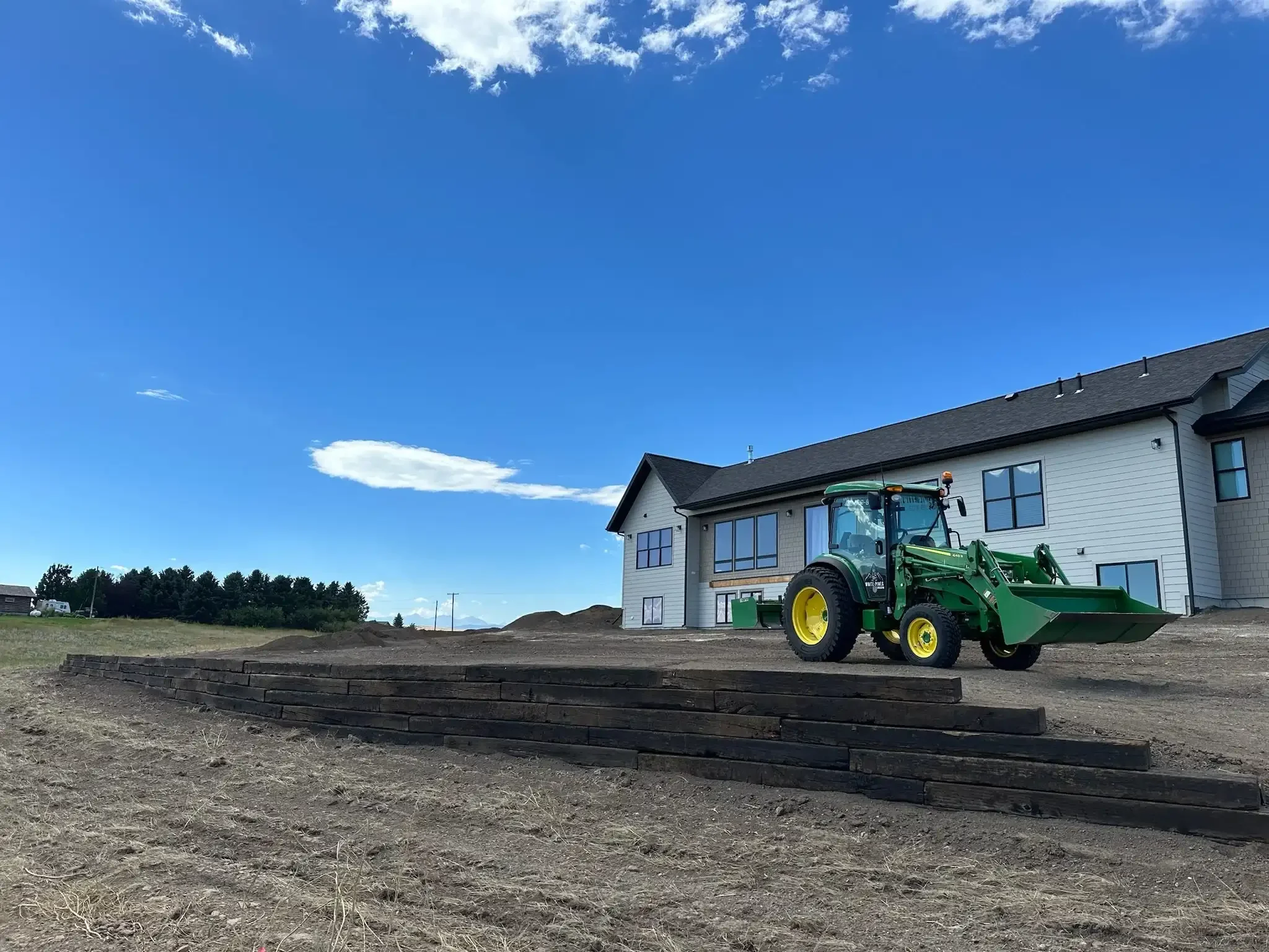 Railroad tie retaining wall, built for structural integrity and visual appeal near Bozeman.