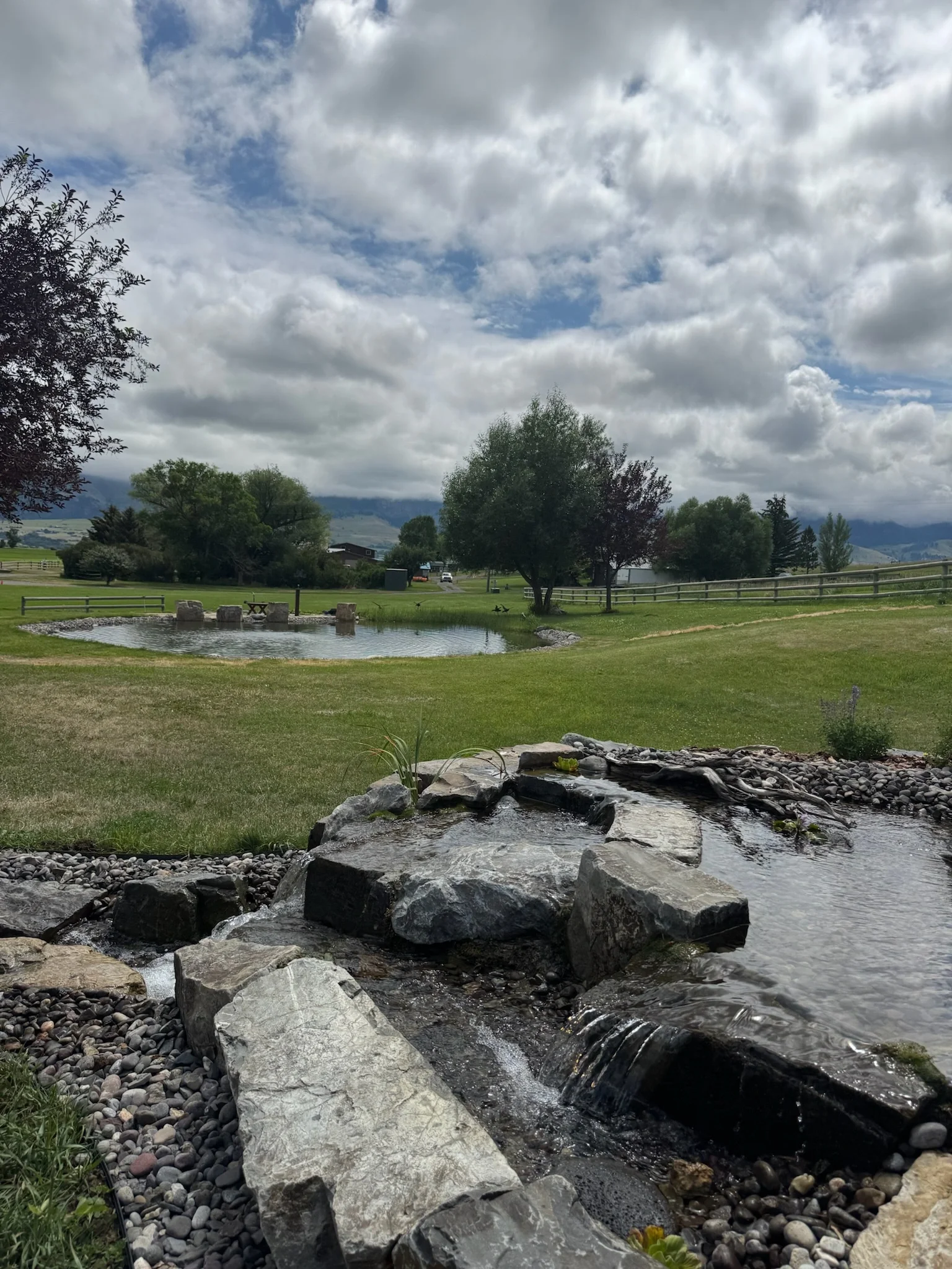 Custom water feature with large boulders and waterfalls - built in Livingston, Montana in Paradise Valley.