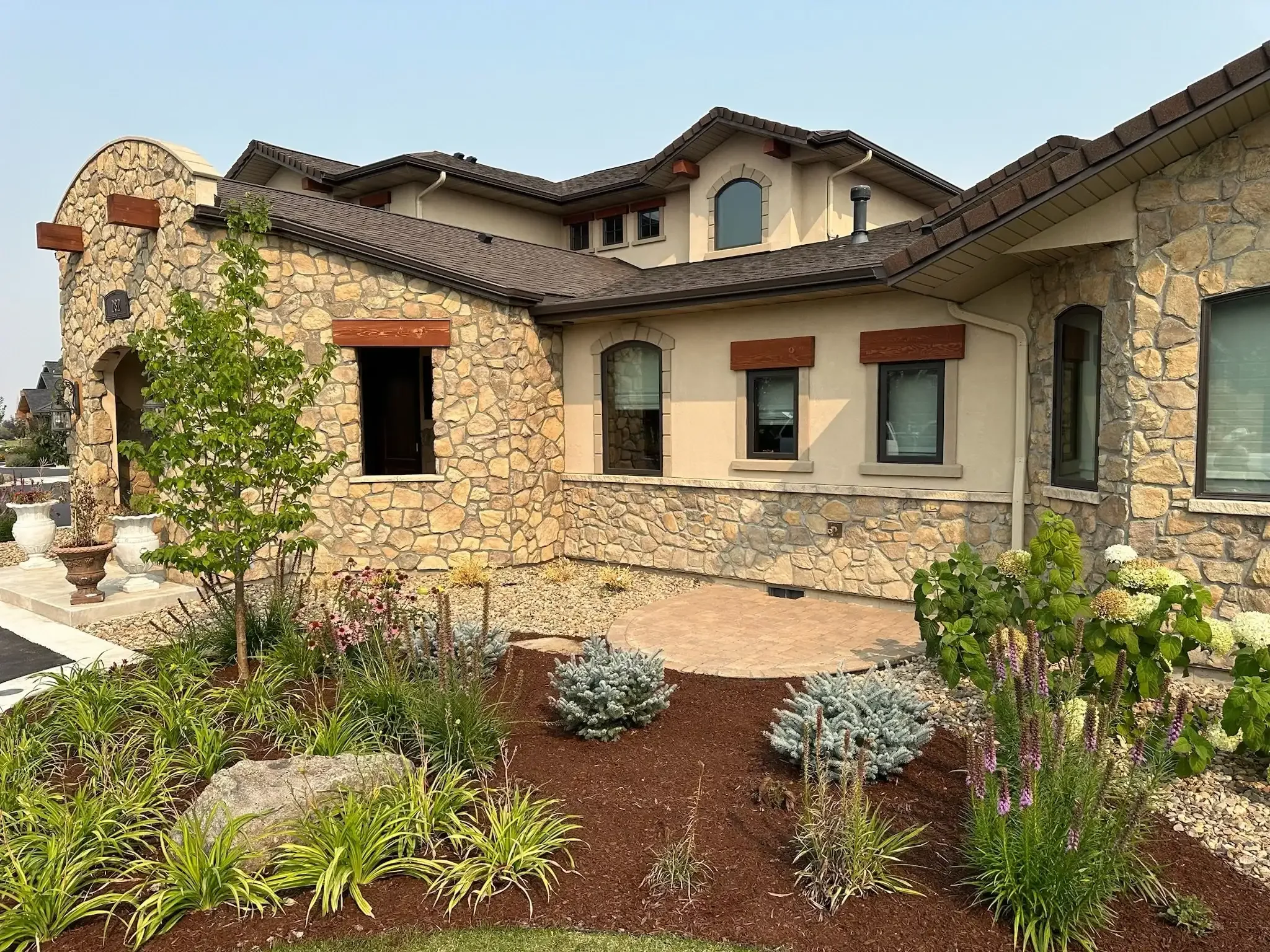 Luxury landscaping bed with a small custom paver patio area -installed in Bozeman
