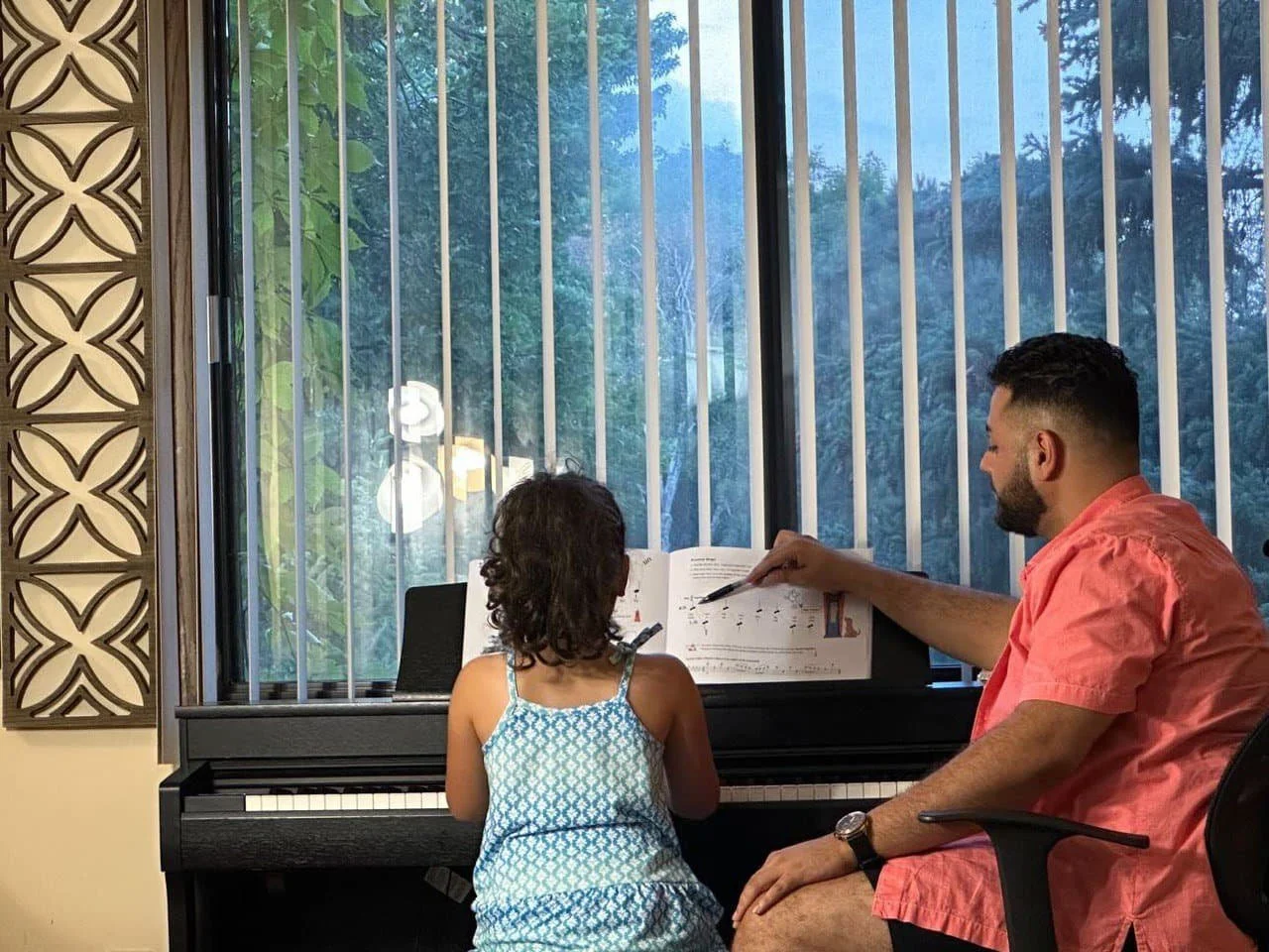 Soroush teaching piano to his student Shima.