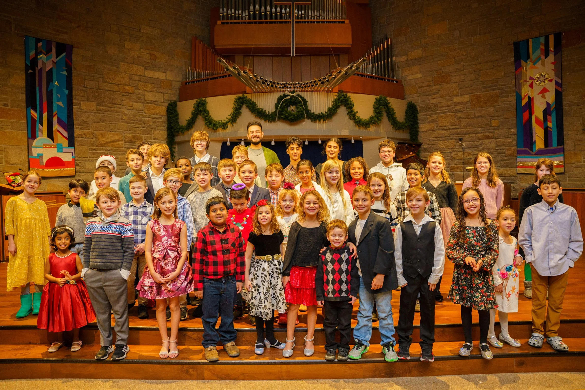 Students, families, and teachers gathered for a group photo at the Naji Piano School February 2023 recital.