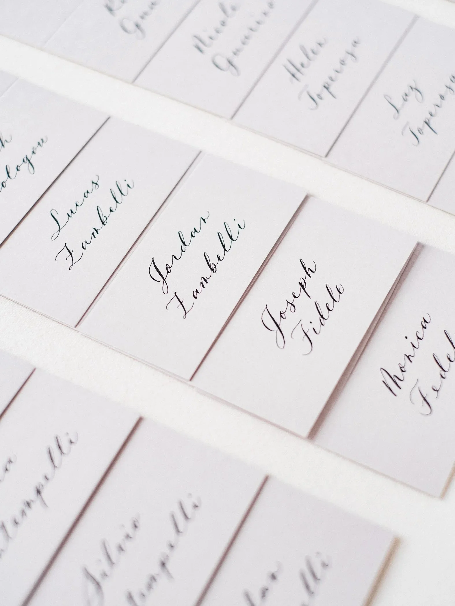 this image shows beautiful calligraphy handwriting on place cards for weddings and events
