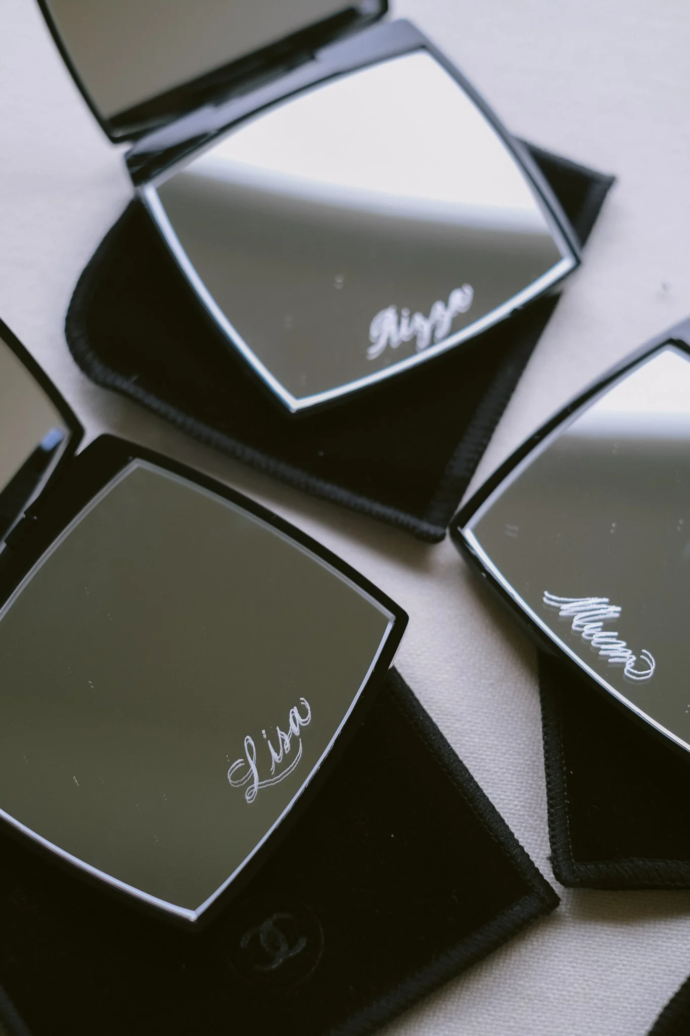 Calligraphy engraved chanel compact mirrors.