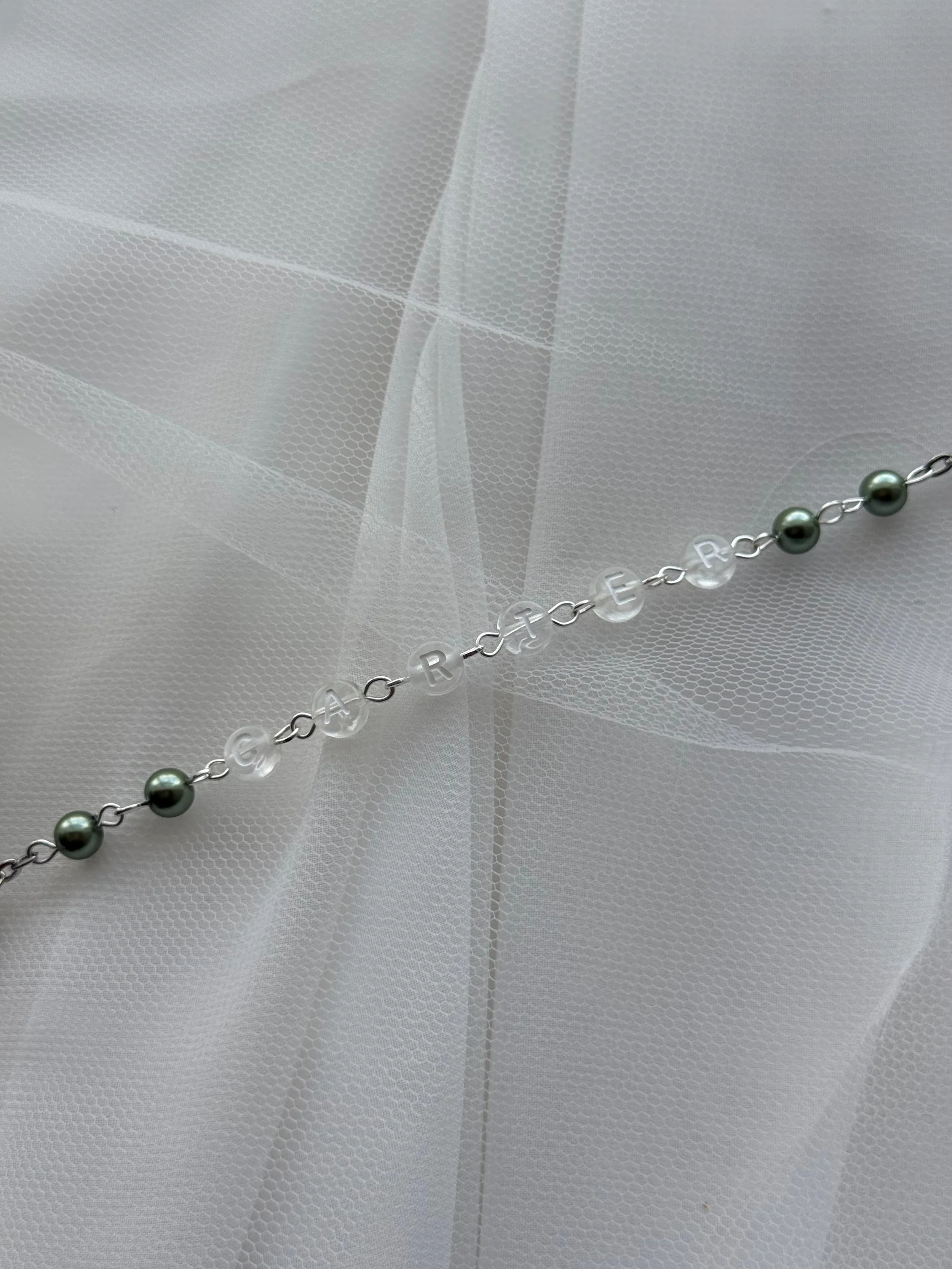 Close up sage green rosary beads with crucifix personalised Catholic rosary gift