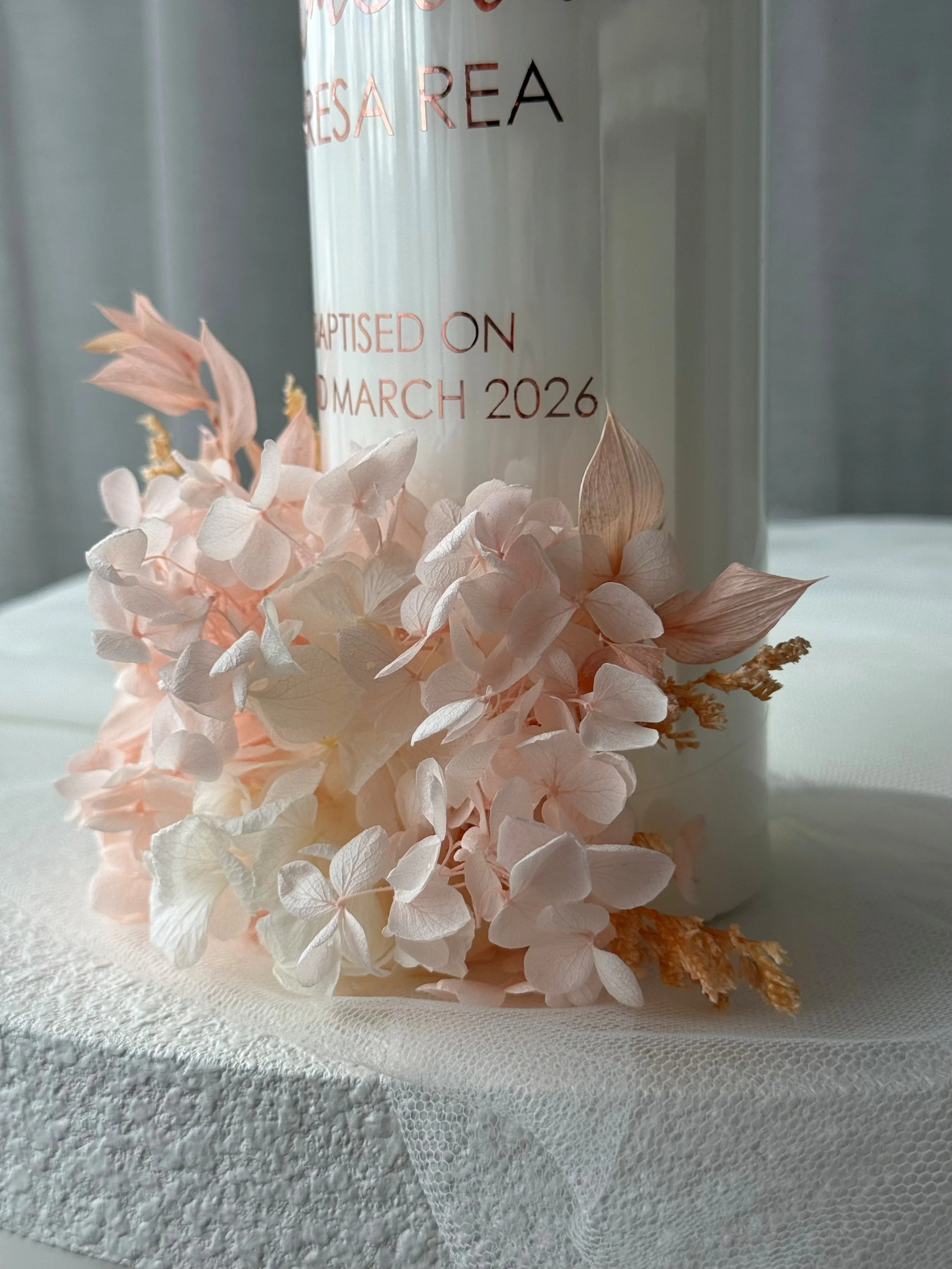 Close up preserved floral baptism candle personalised with baby name and baptism date