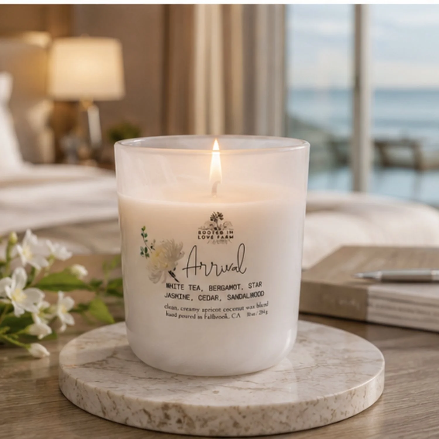 Arrival 10 oz lit, front of candle in hotel room with window to sea.jpg