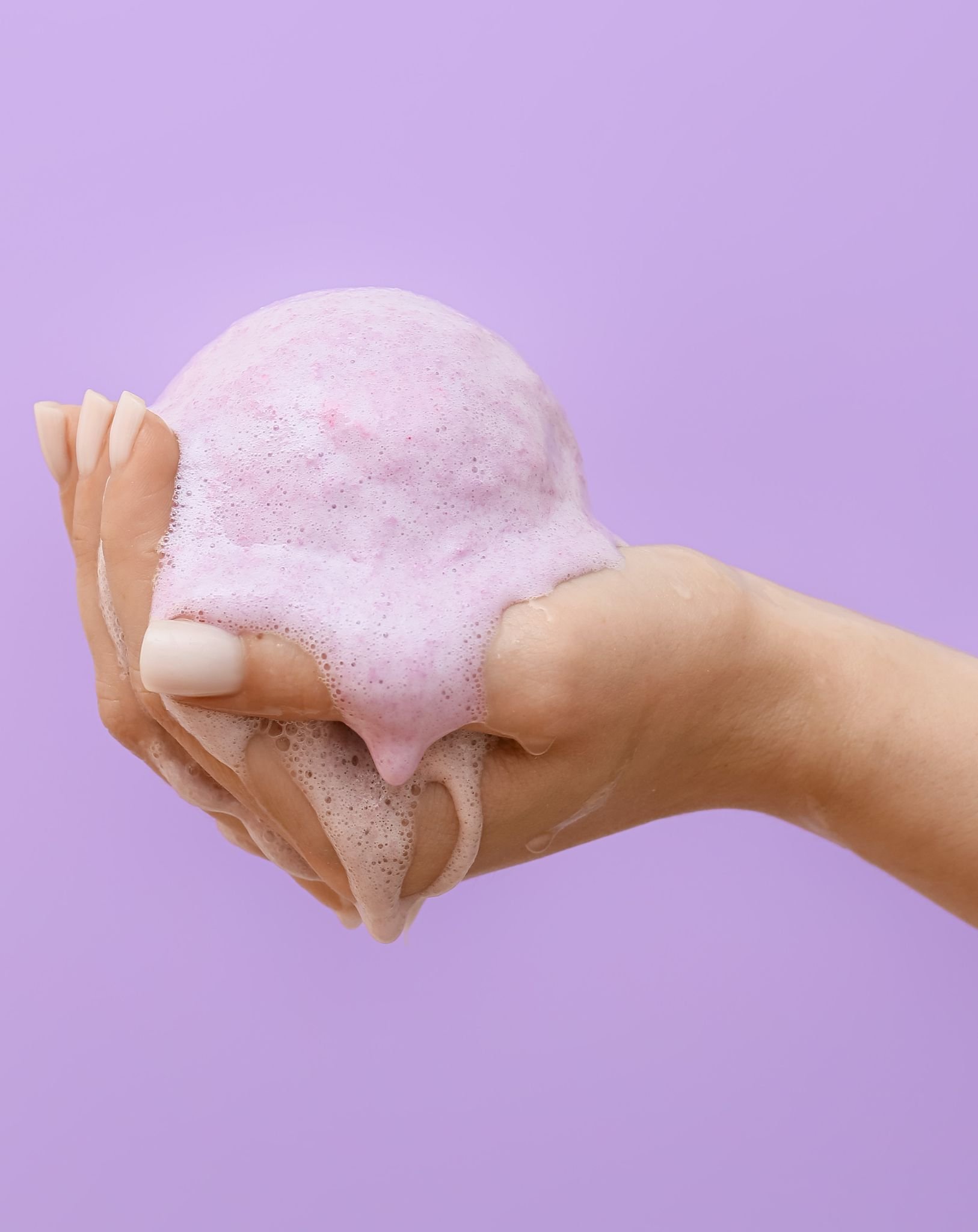 Woman holding fizzing bath bomb.jpg