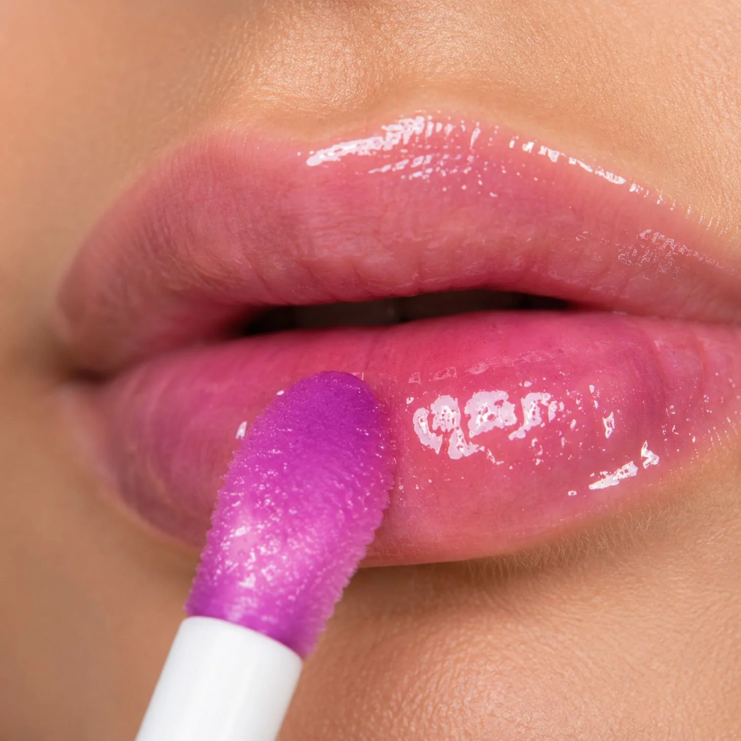 Wild Berries Lip Jelly Gloss close of applying to lips.jpg
