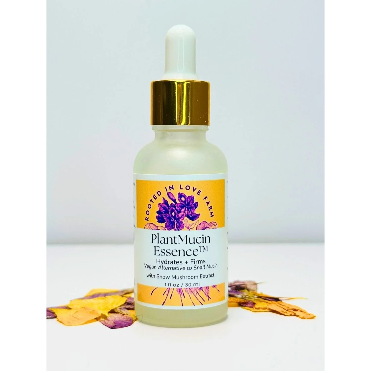 PlantMucin Essent by Rooted in Love Farm with Snow Mushroom Extract on white background with flower petals.jpg