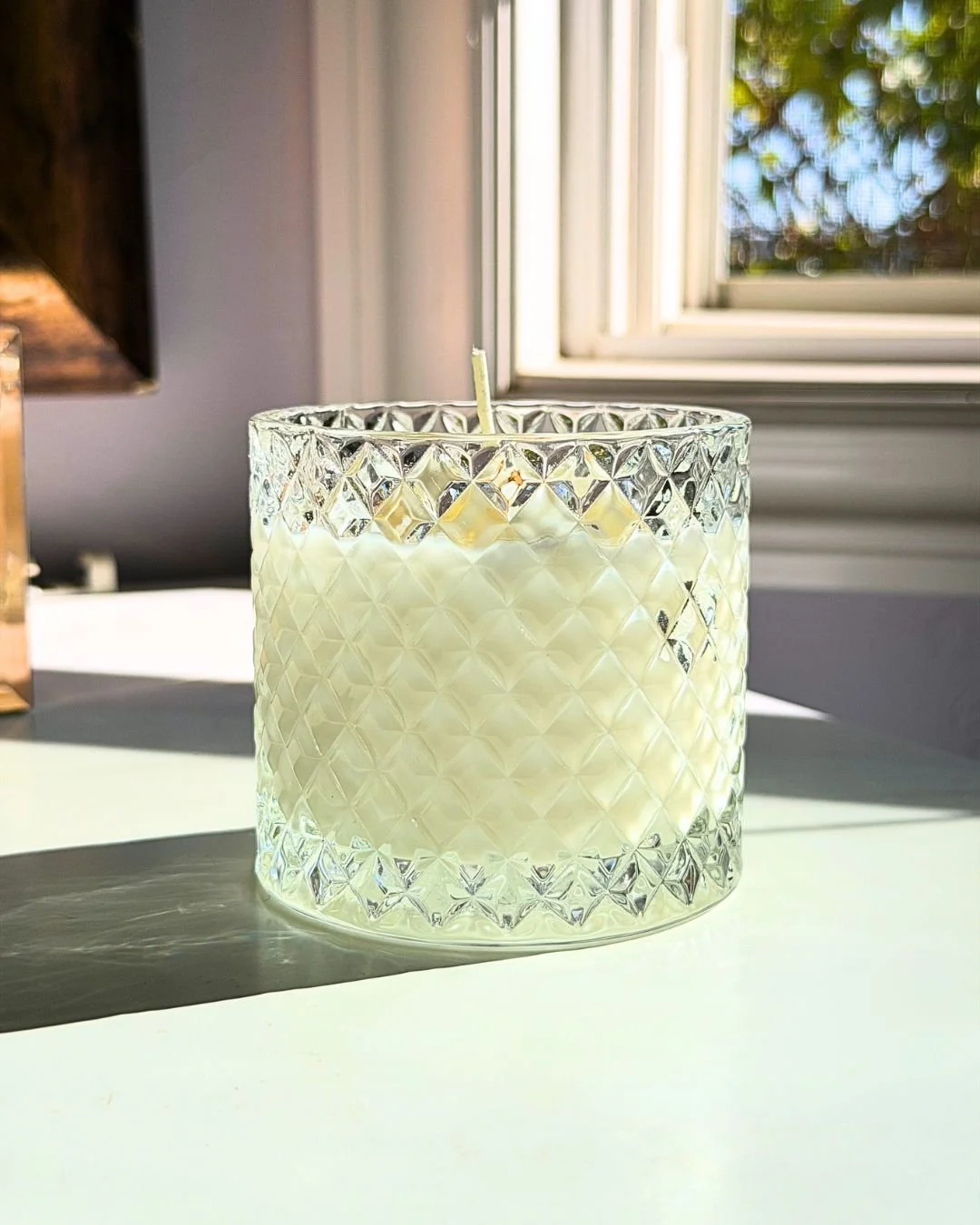 yuzu citrus candle front with greenery background.jpg