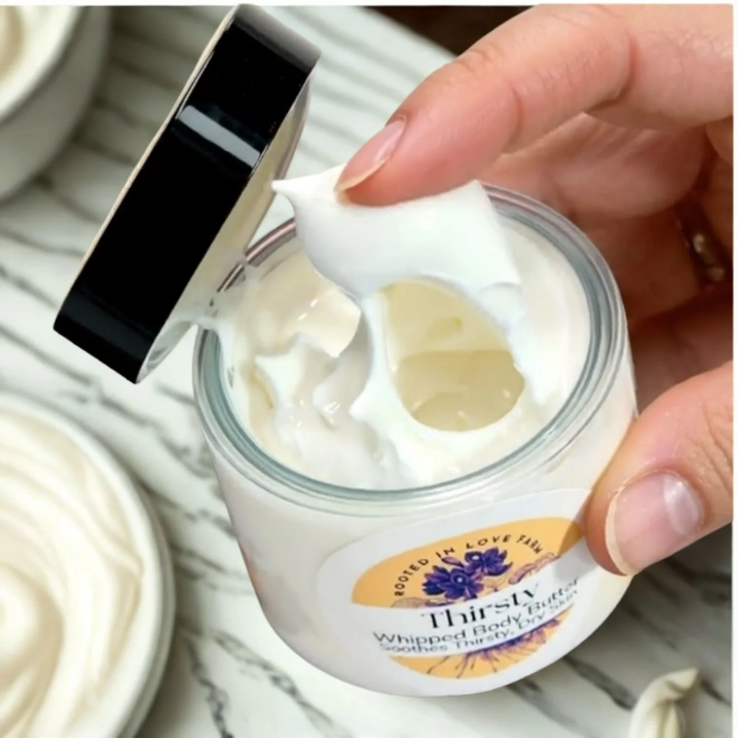 Close up of finger in Thirsty Whipped body butter.jpg