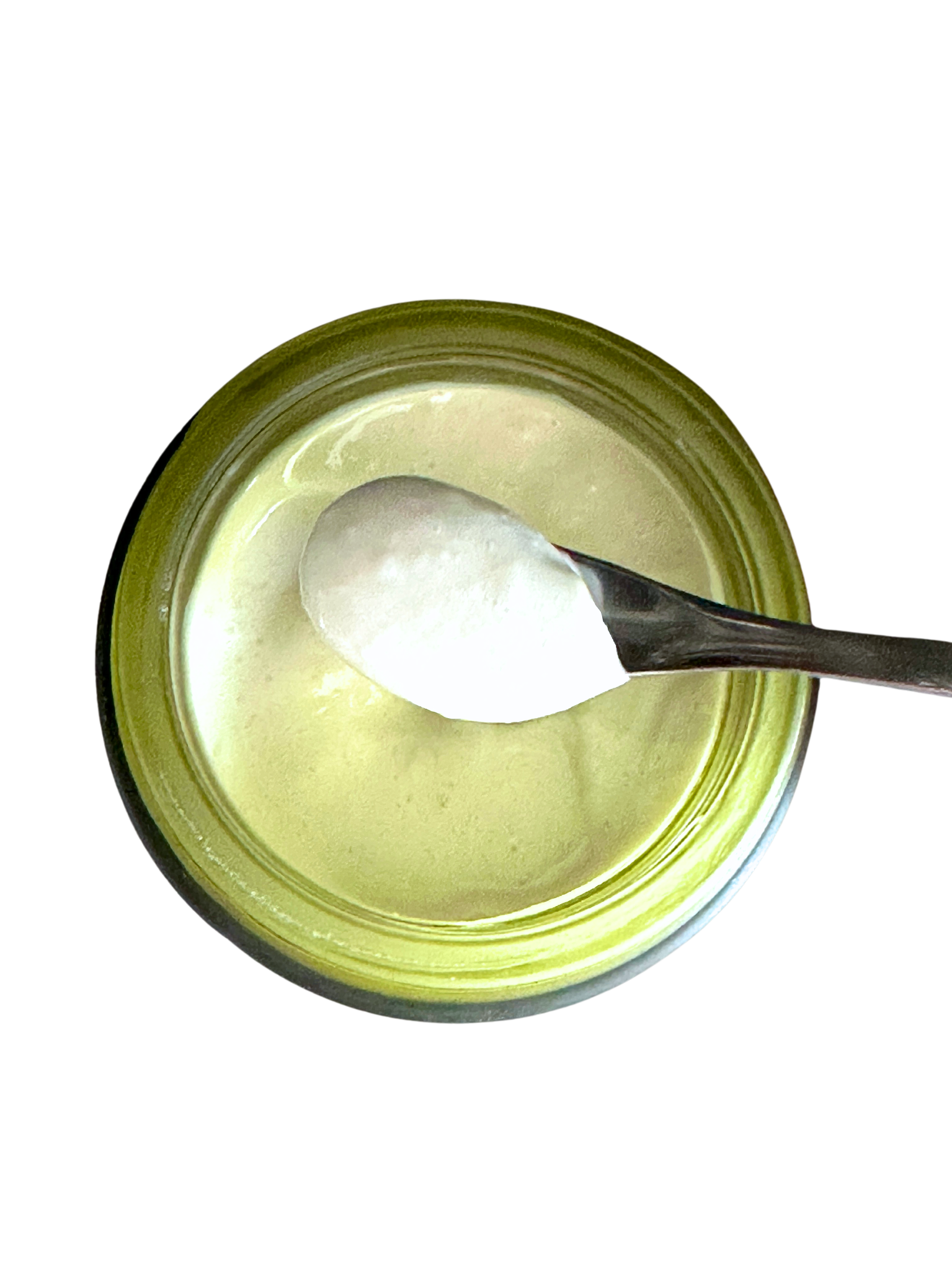 Top-down view of Illuminate face cream showing creamy texture on a spoon