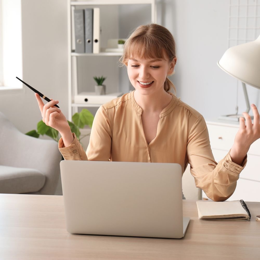 Energise your job searching - a female in a beige blouse is having an online interview in her smart, white home