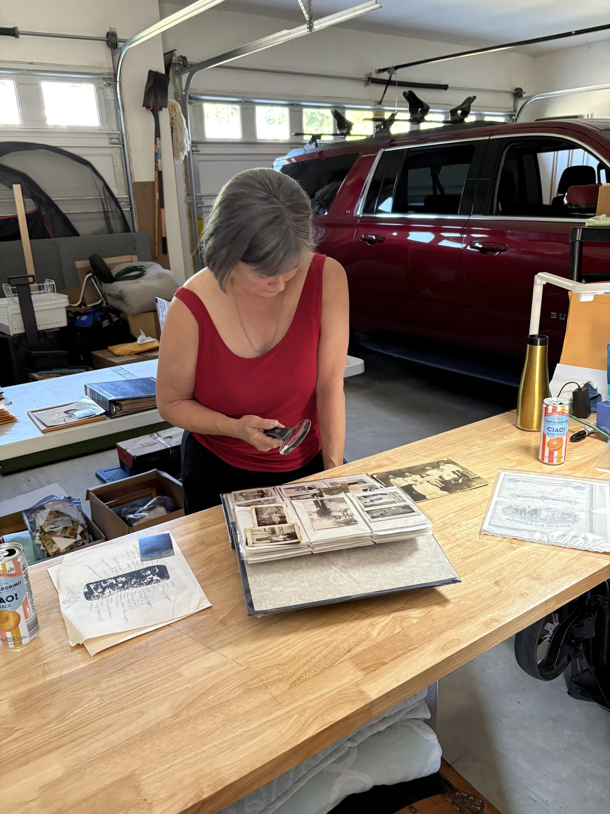Maria Lynn Barrs author of the Vicky Robeson Mystery Series searches photos in garage.