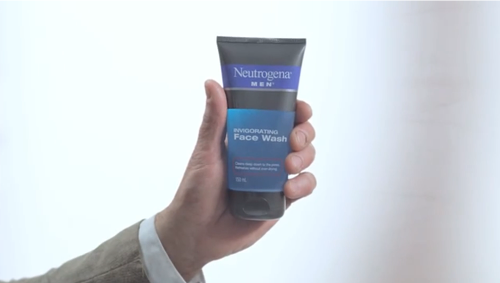 hand holding Neutrogena MEN bottle