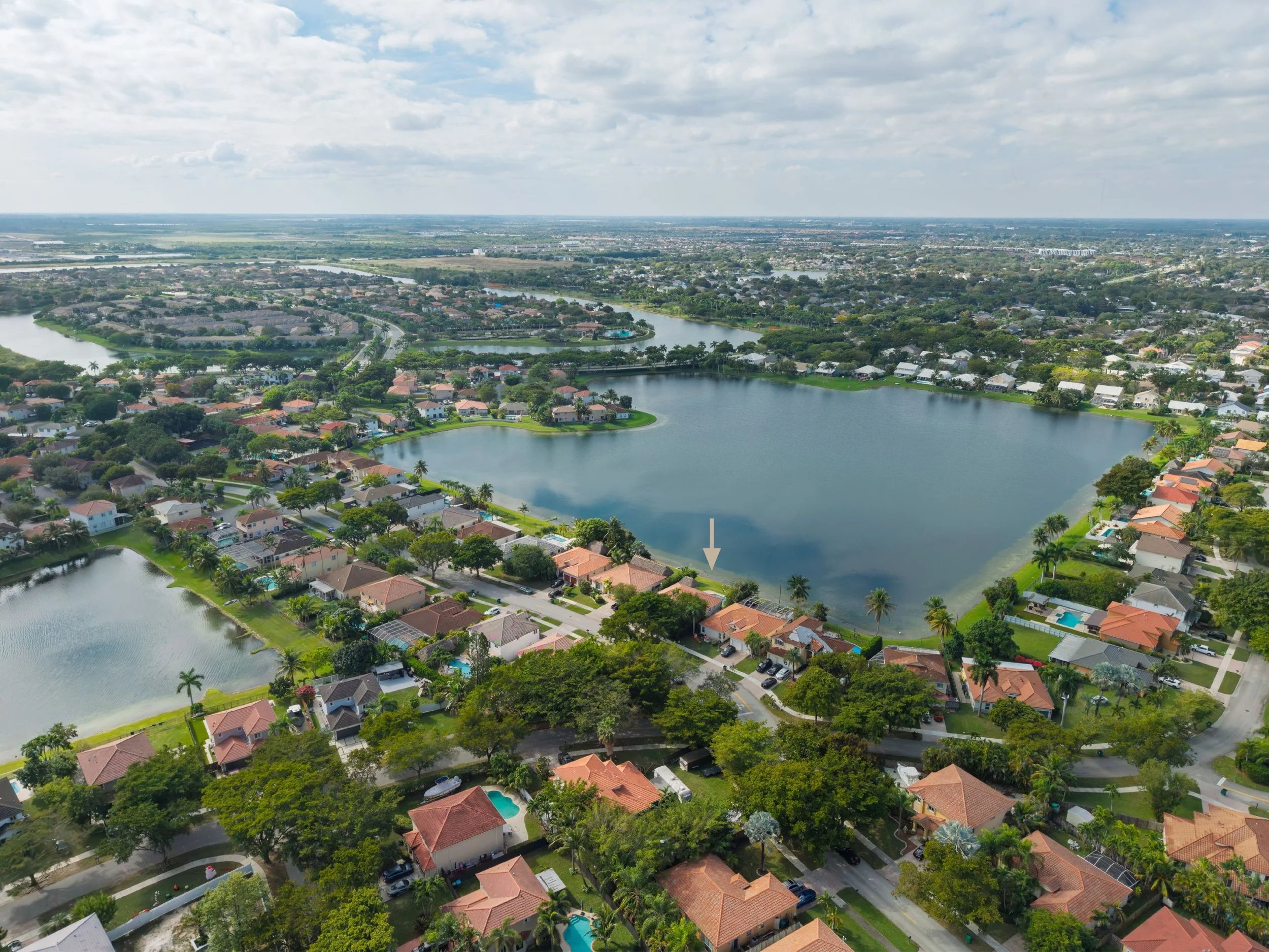Aerial view of Lakes by the Bay in Cutler Bay, showing the lakefront neighborhood and the home’s position along the water.