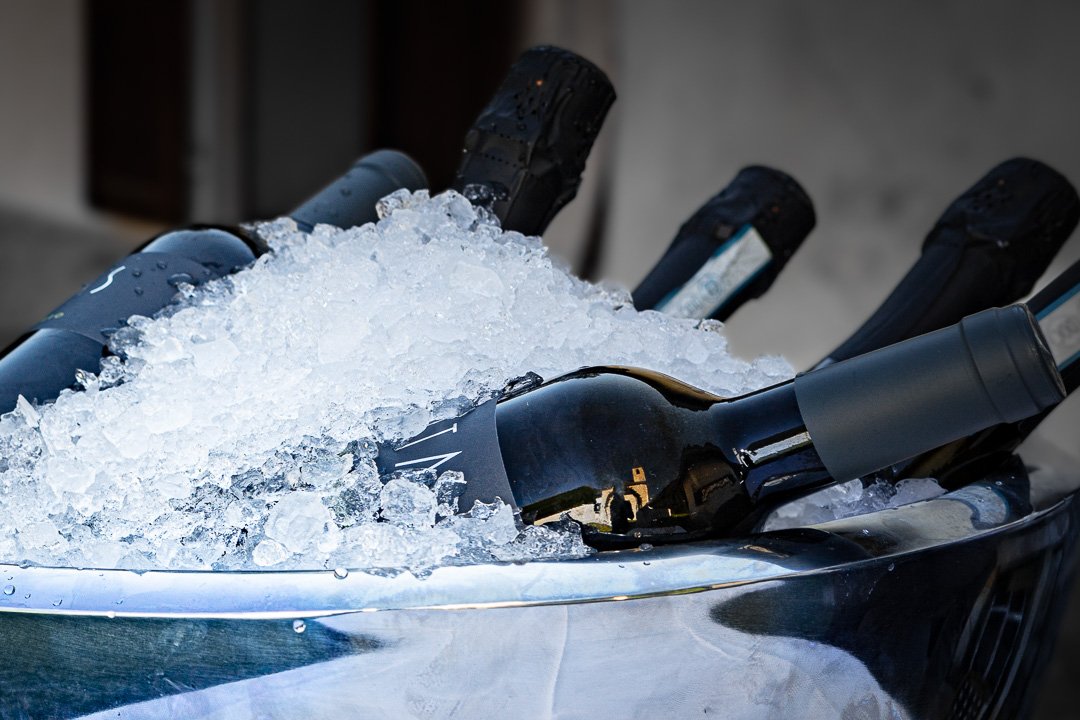 Mehrere Flaschen Sekt oder Champagner in einem Eiskübel mit Eiswürfeln gekühlt.