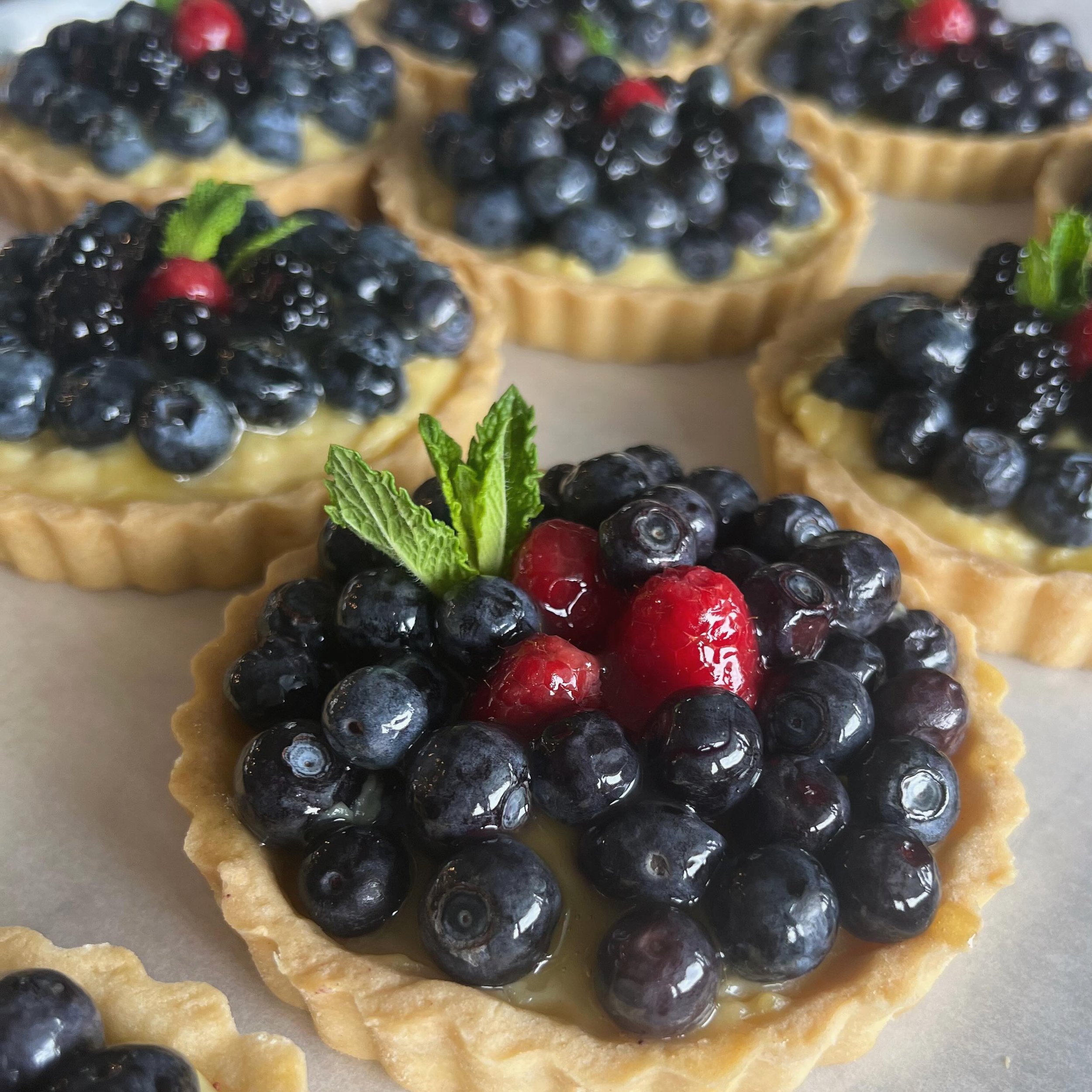 🌸 Queen of Hearts Tart 🌸
.
.
Fresh blueberries and a smooth vanilla pastry cream cradled in a shell of Shugah&rsquo;s buttery shortbread.
.
Mother&rsquo;s Day preorders are now live! Order through our website by May 5 for pick up Saturday May 11th 