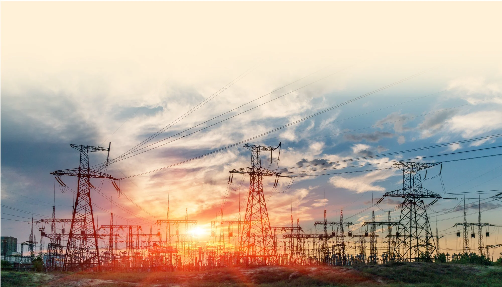 Power transmission towers at sunset delivering electricity generated from natural gas