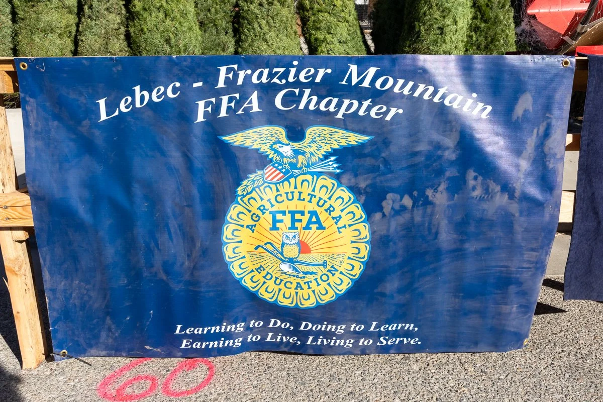 Blue banner with white text reading "Leben - Frazier Mountain FFA Chapter," with the FFA emblem featuring an eagle, shield, and owl, and the slogan "Learning to Do, Doing to Learn, Earning to Live, Living to Serve."