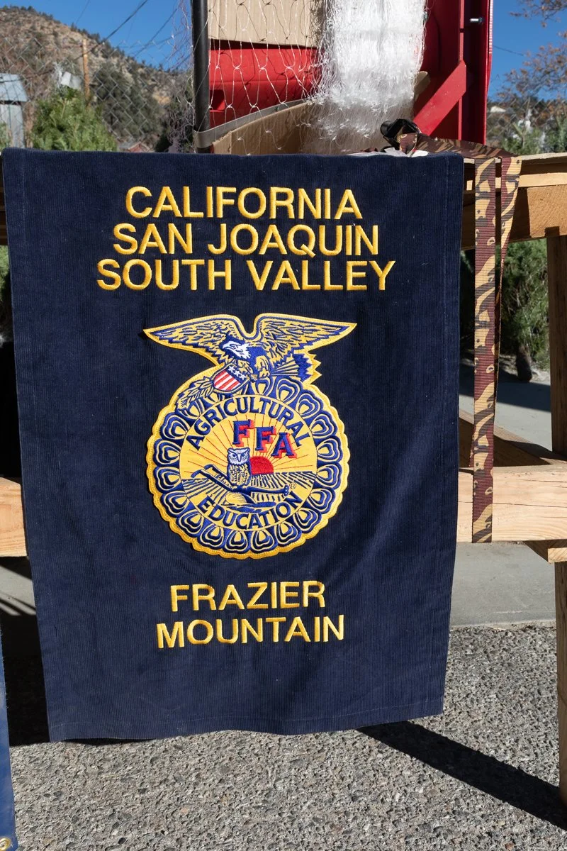 A blue cloth with yellow embroidered text and a logo, indicating it represents the California FFA South Valley chapter from Frazier Mountain. The logo features an eagle, a farm scene, and the words 'Agricultural Education'.