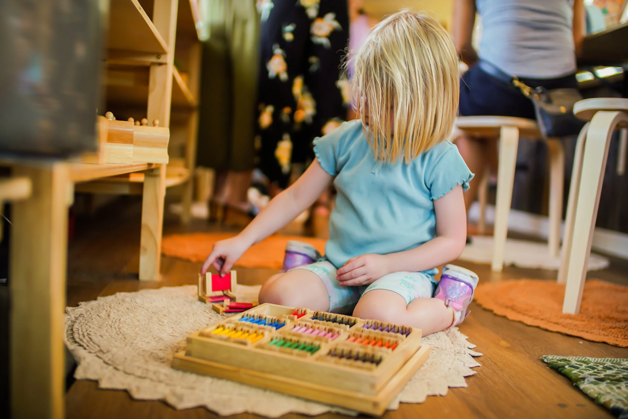 a young girl working with the color tablets