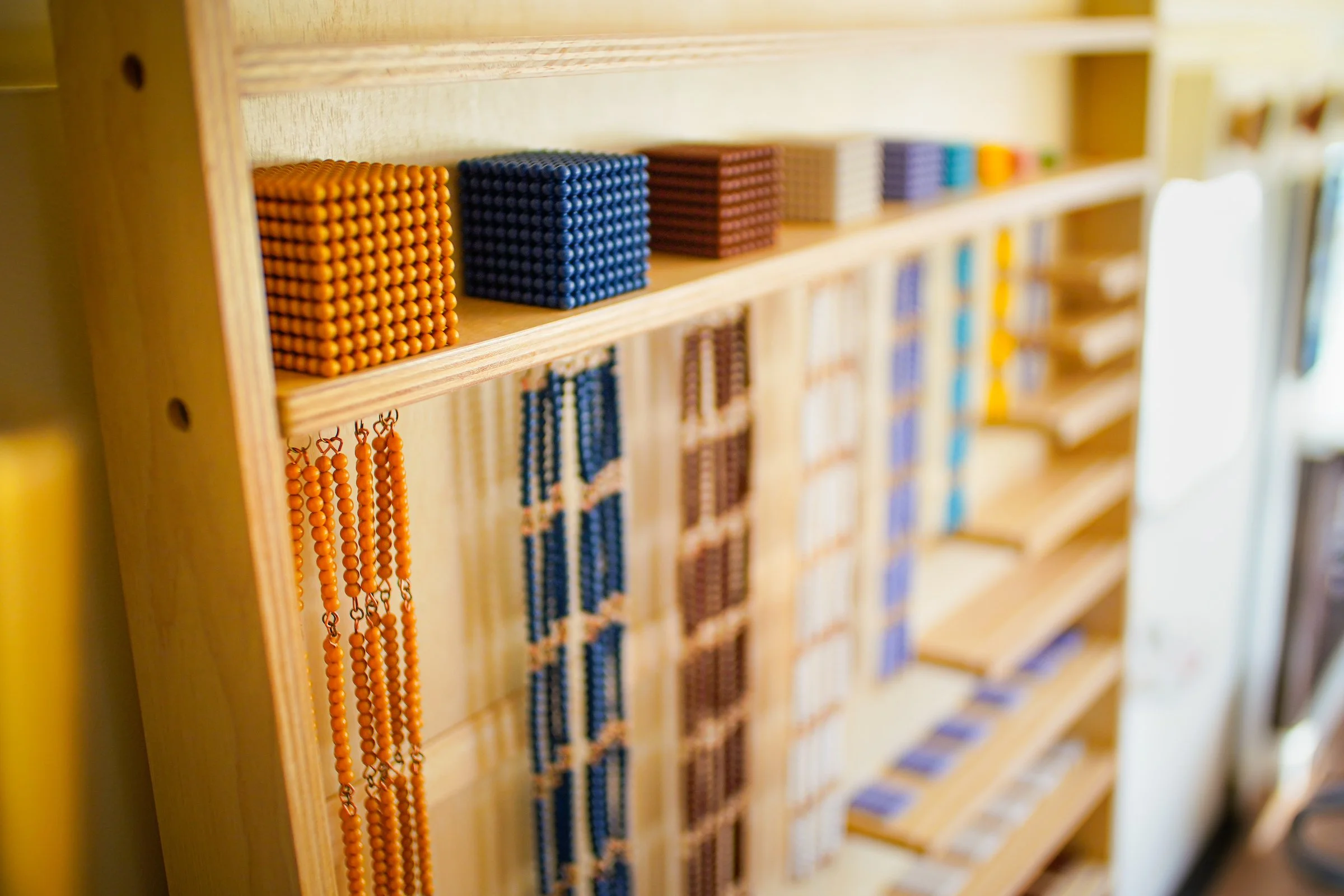 The montessori bead cabinet is shown, with the thousands cube in the foreground.