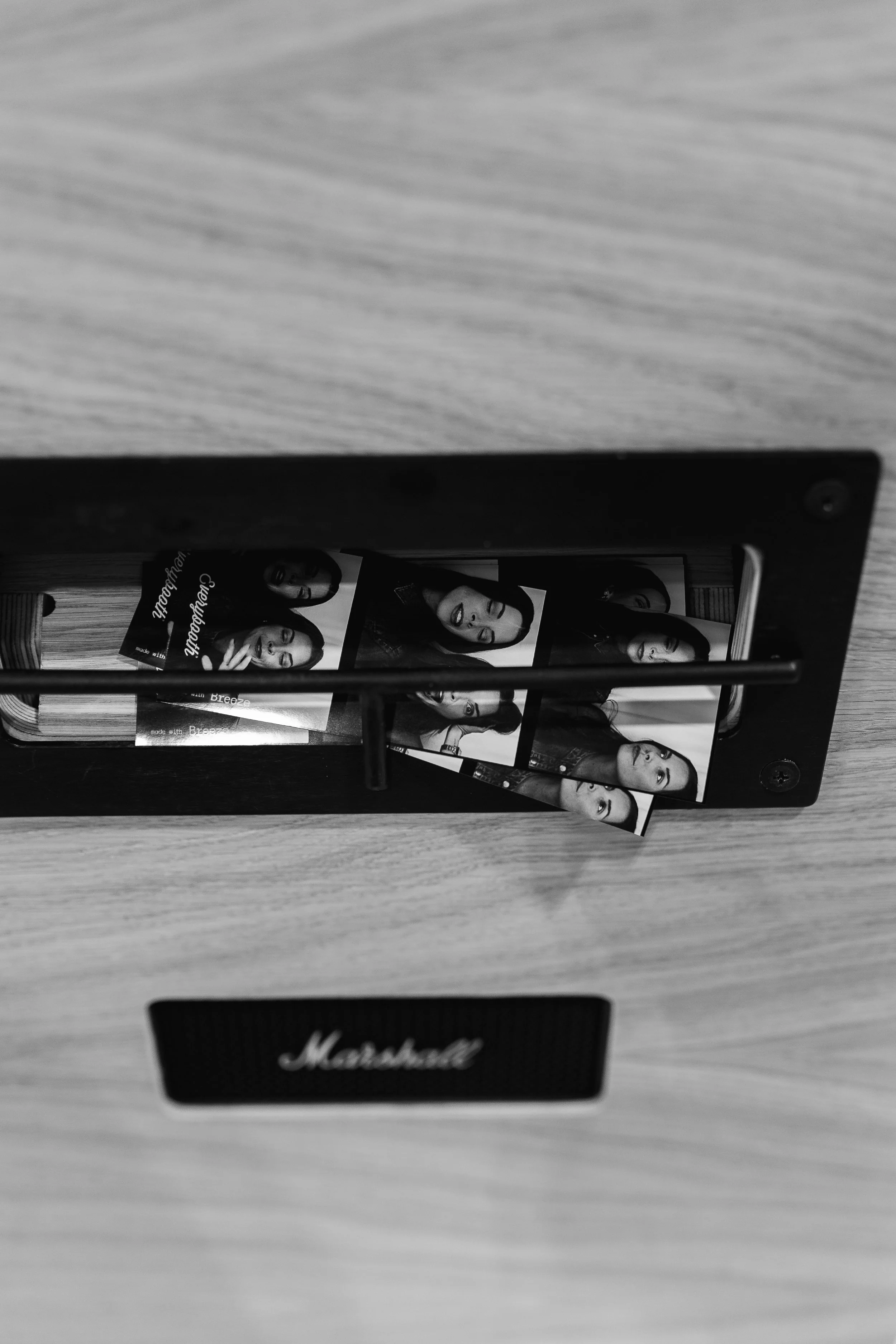 A photo of a photoslide with pictures of a woman, placed on a wooden surface inside a rectangular frame.