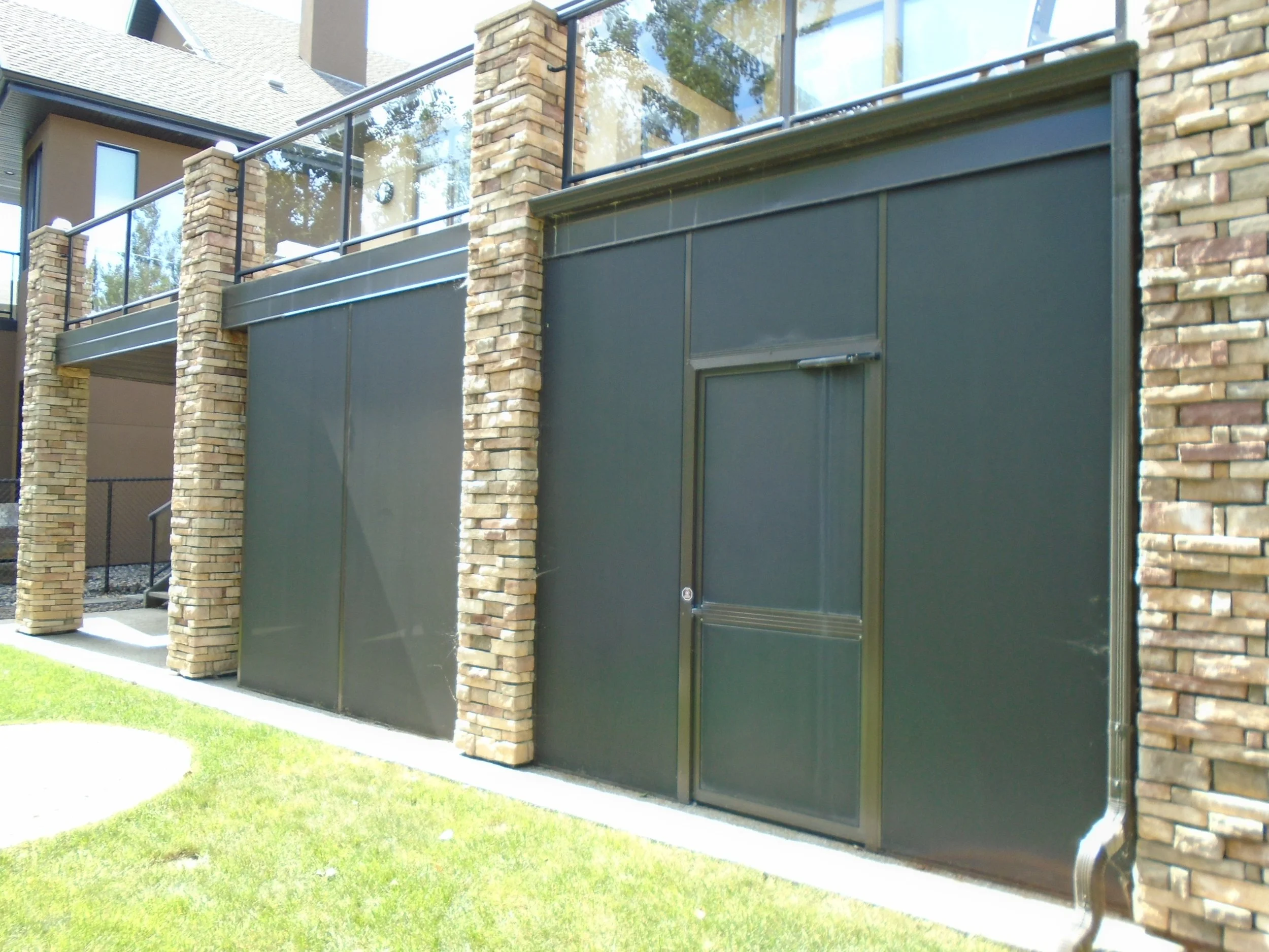 Screenroom for walk-out basement, under an existing deck above.