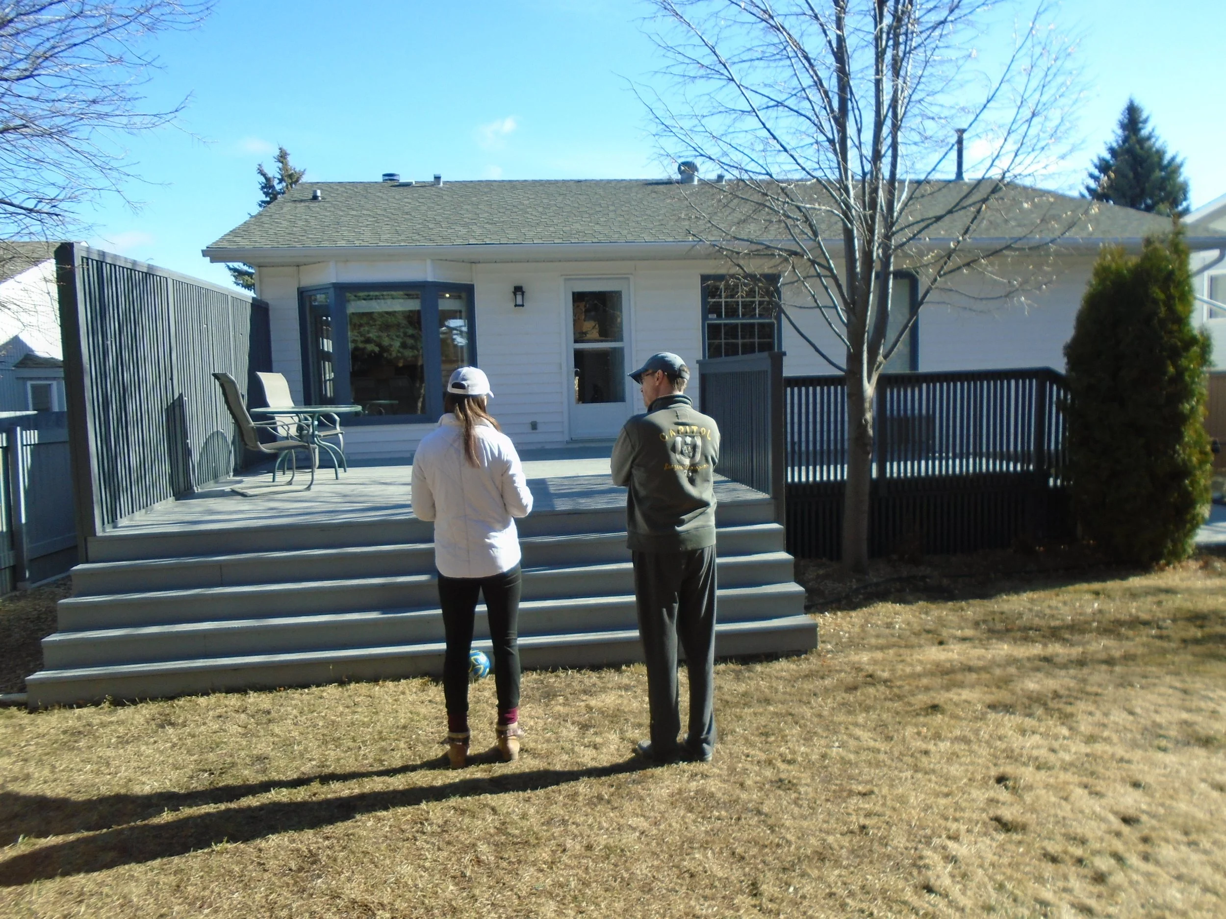 Rear wood deck and privacy screen.