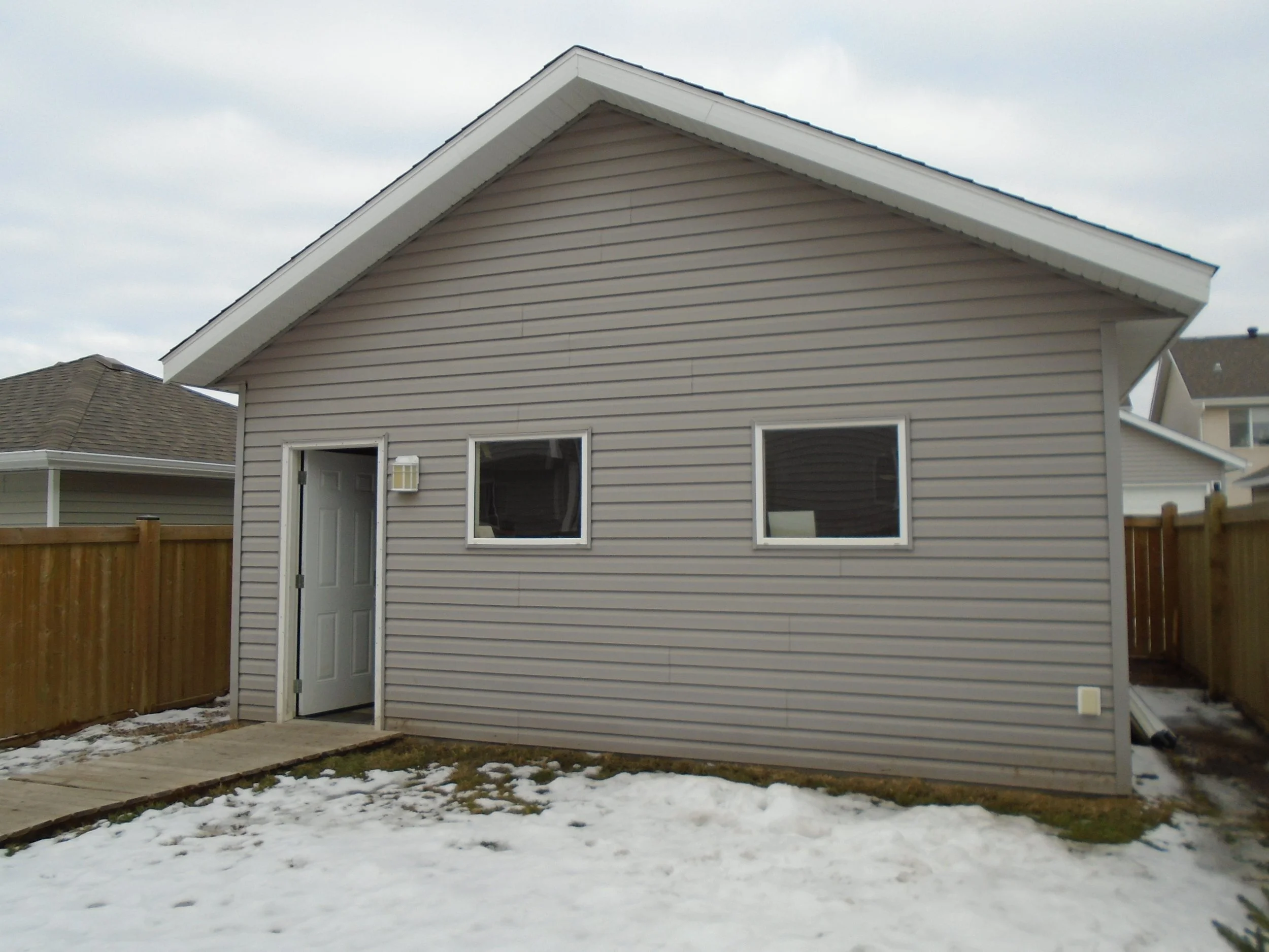 Rear, detached garage requires development permit and building permit.