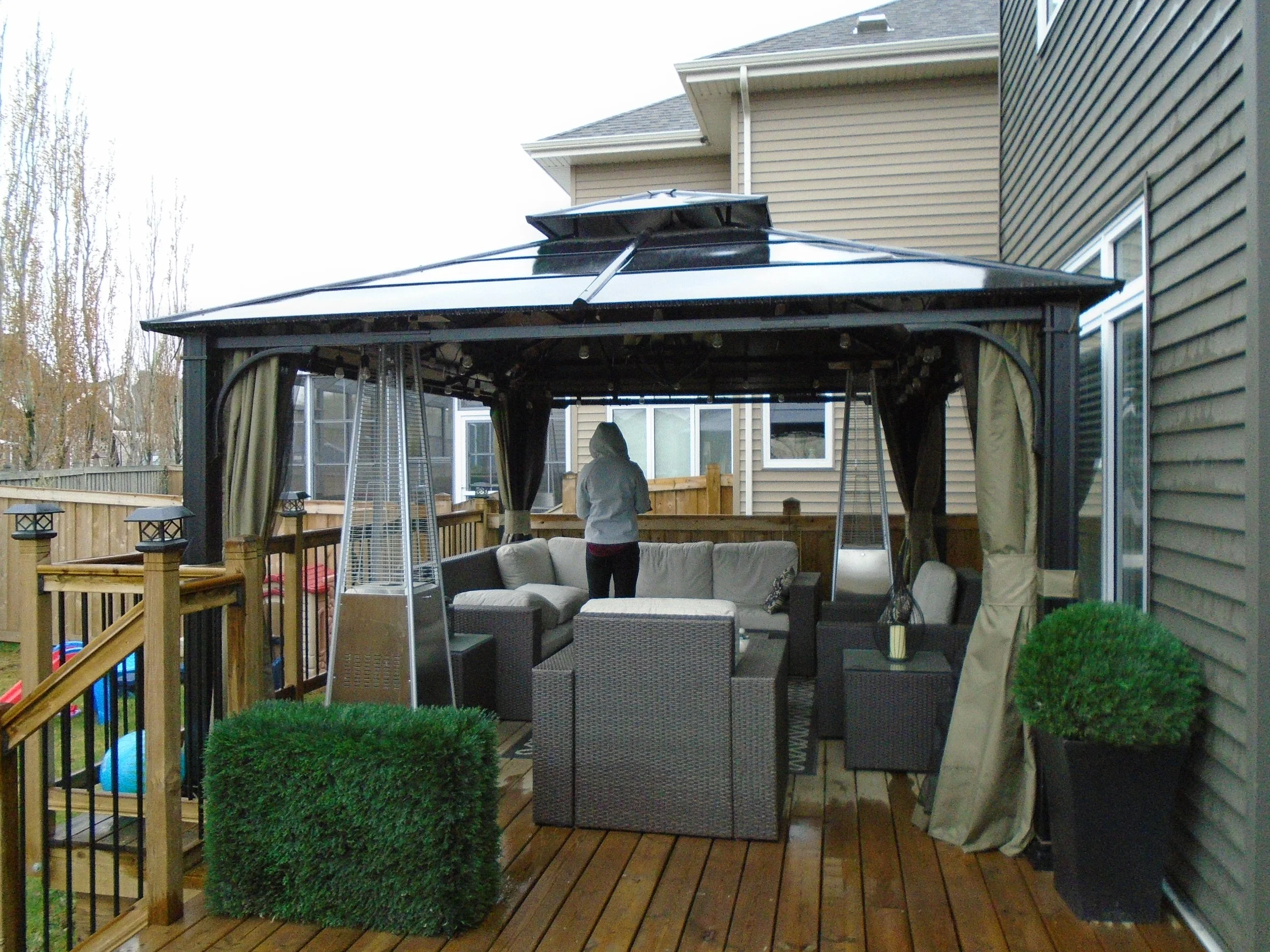 Premanufactured metal gazebo on a wood deck.