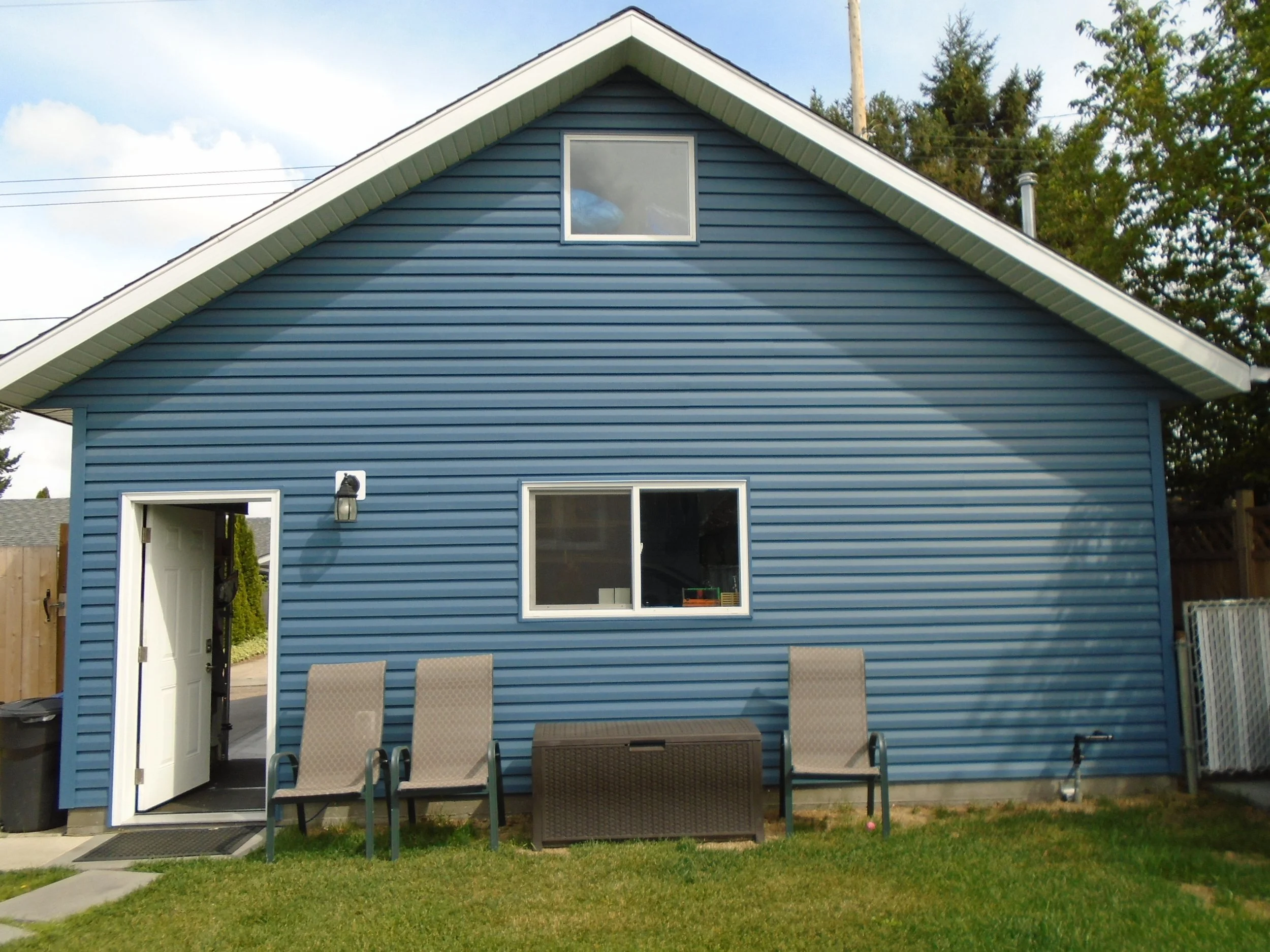 Rear, over-height detached garage with storage space above, requires development permit and building permit.
