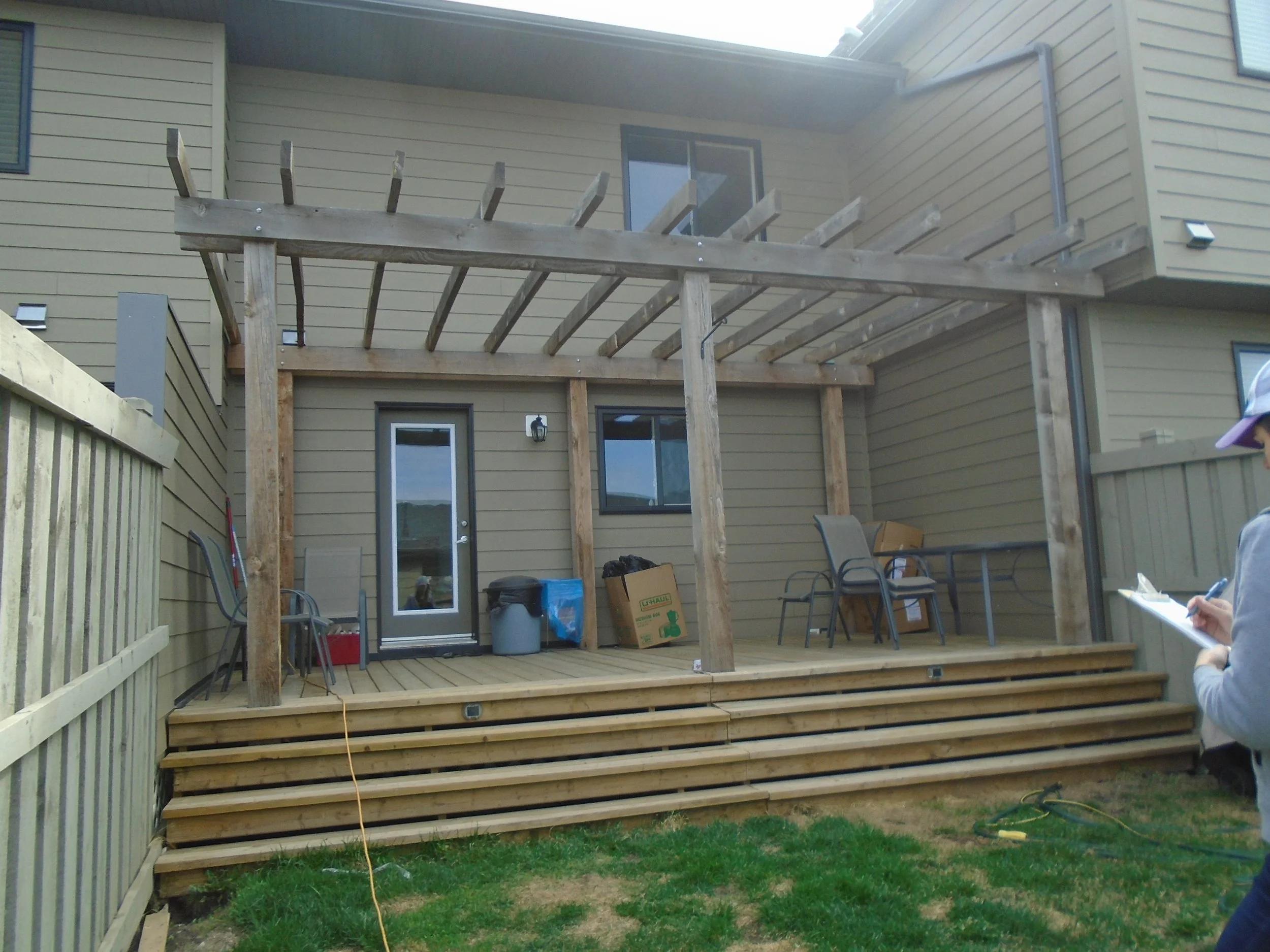 Rear wood deck with wood pergola.
