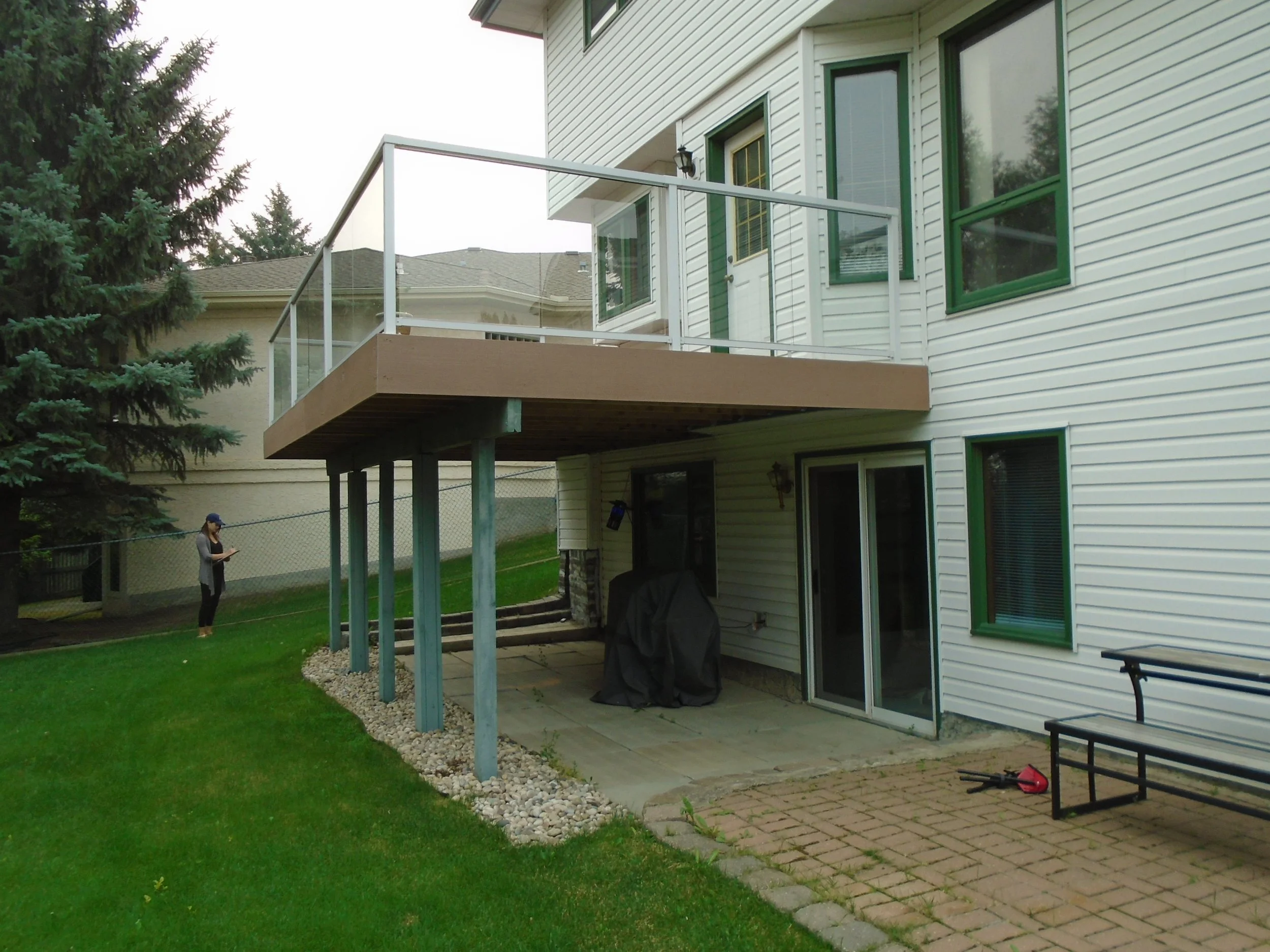 Rear, over height deck with glass handrail.