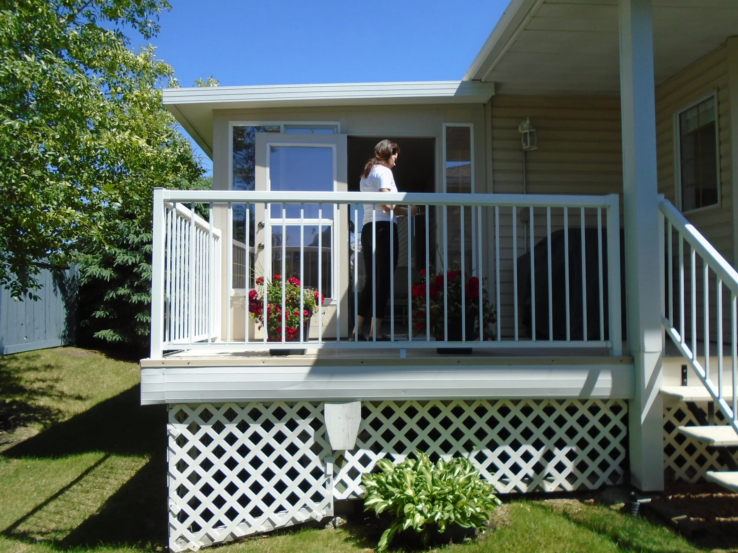 Rear, partially covered wood deck, on condo property. 