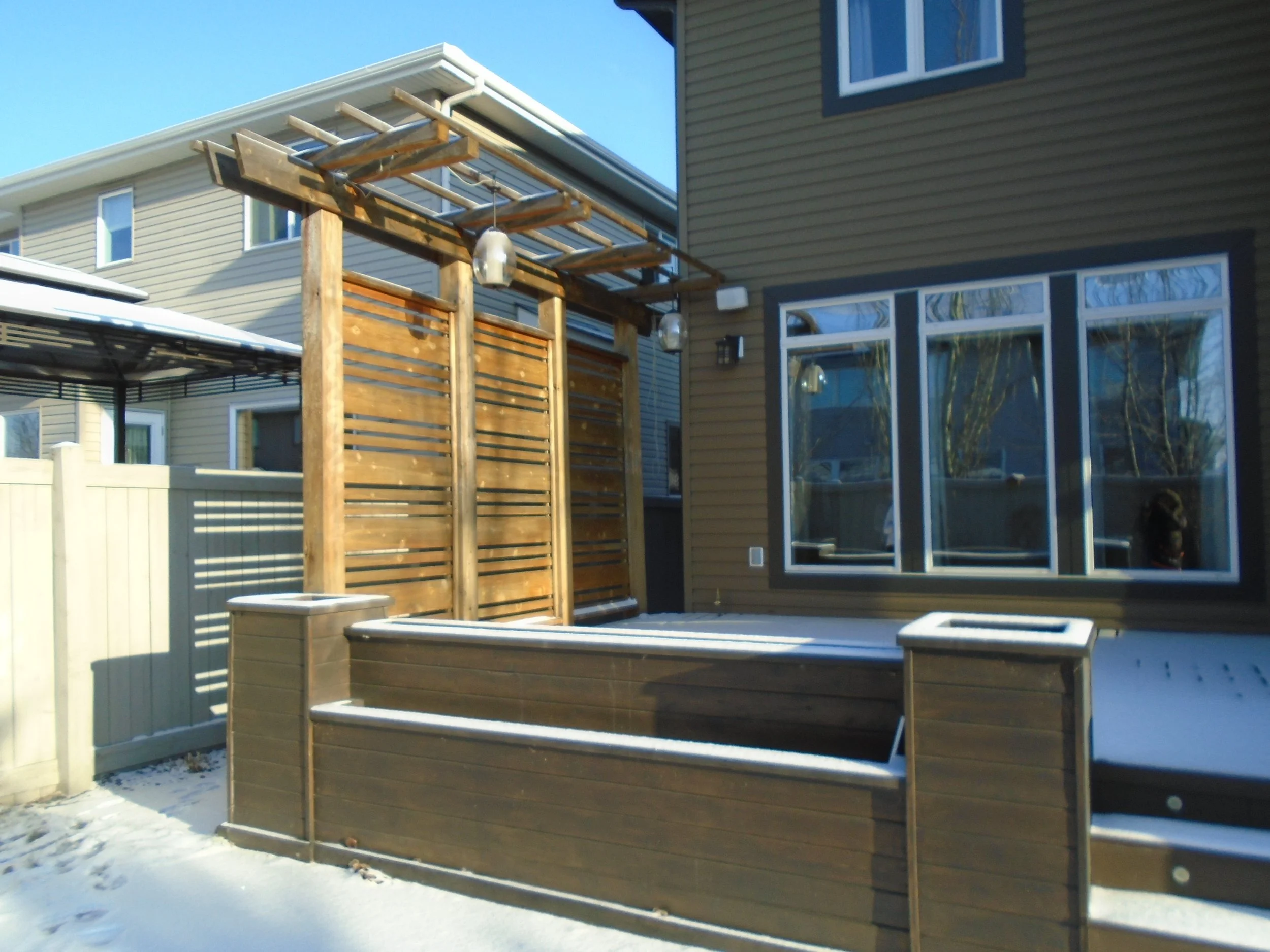 Rear patio with wood privacy screen.