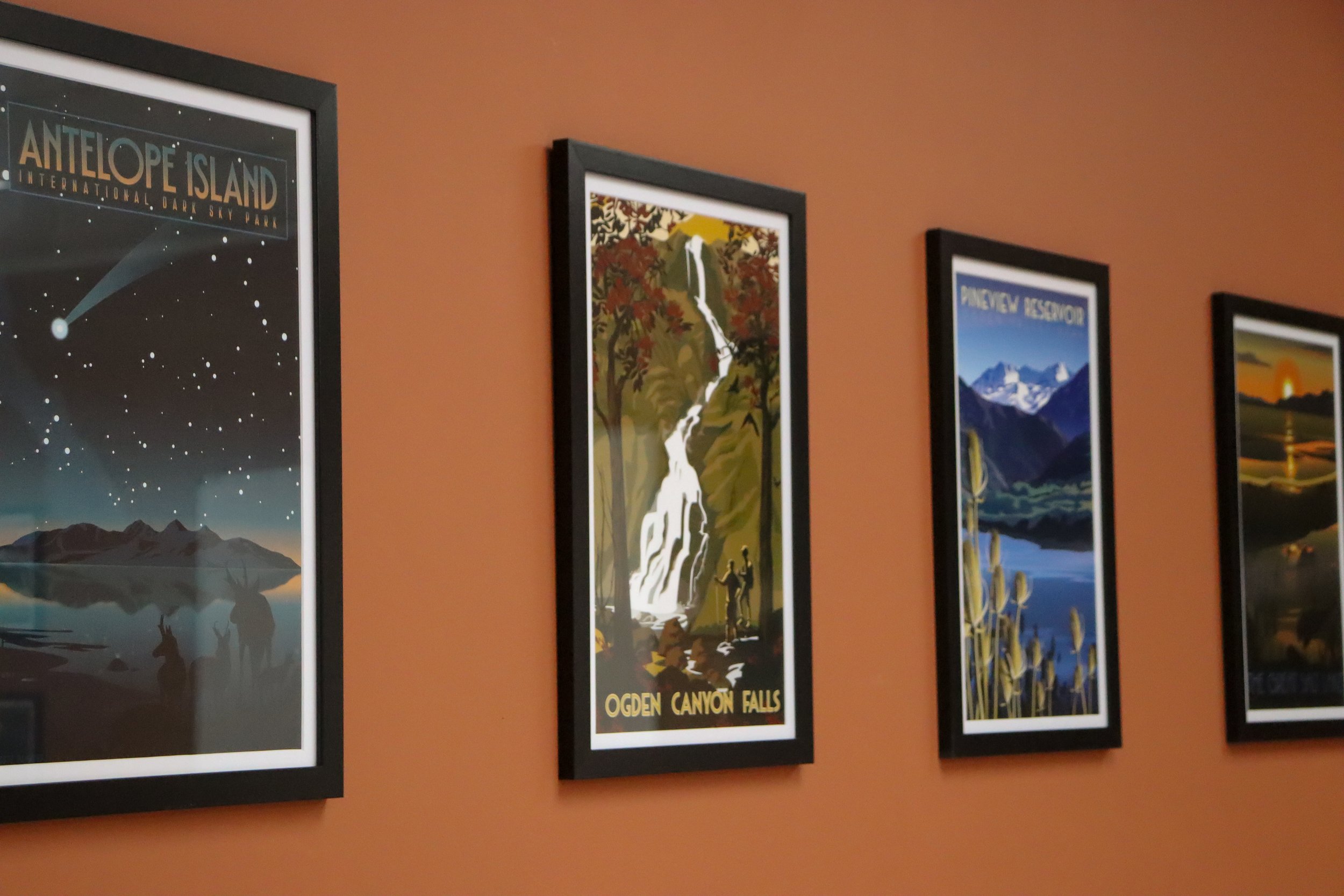 Pictures hanging on wall at group therapy room on burnt orange wall