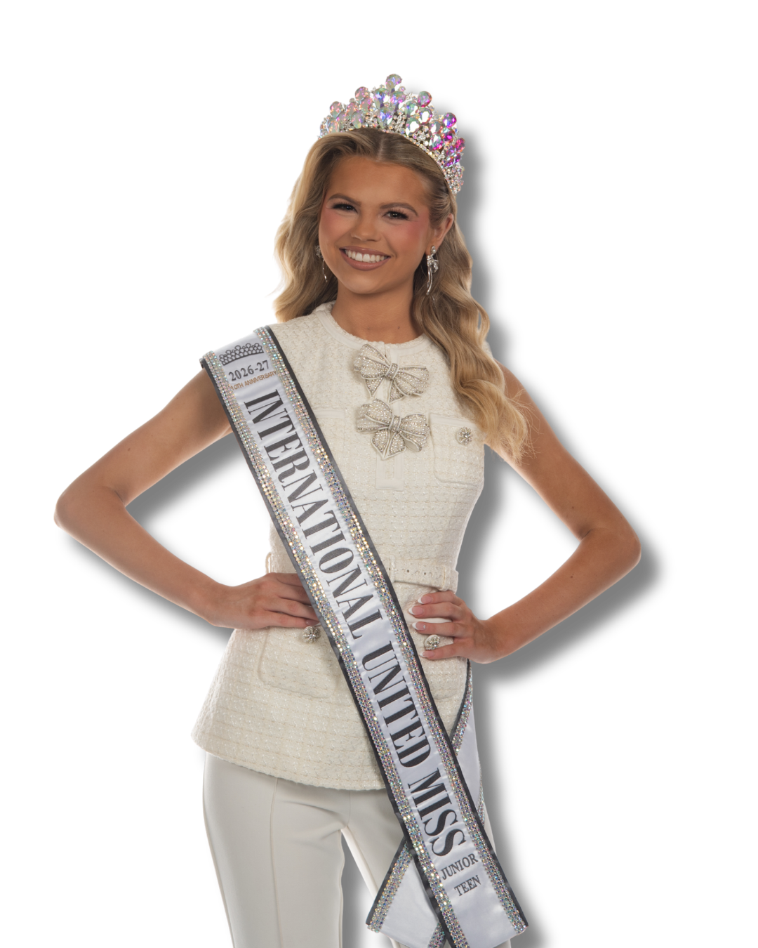 Beauty queen wearing a crown, pink gown, and sash that reads 'International United Miss 2025-26' smiling with hands on hips.