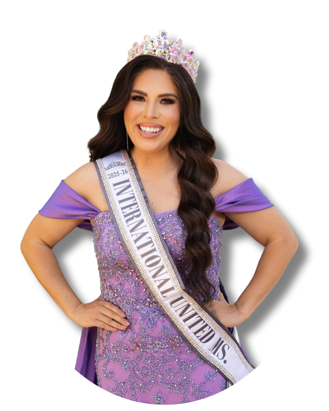 A woman wearing a purple gown, crown, and sash that reads '2025-26 INTERNATIONAL UNITED MS.' smiling with her hands on her hips.
