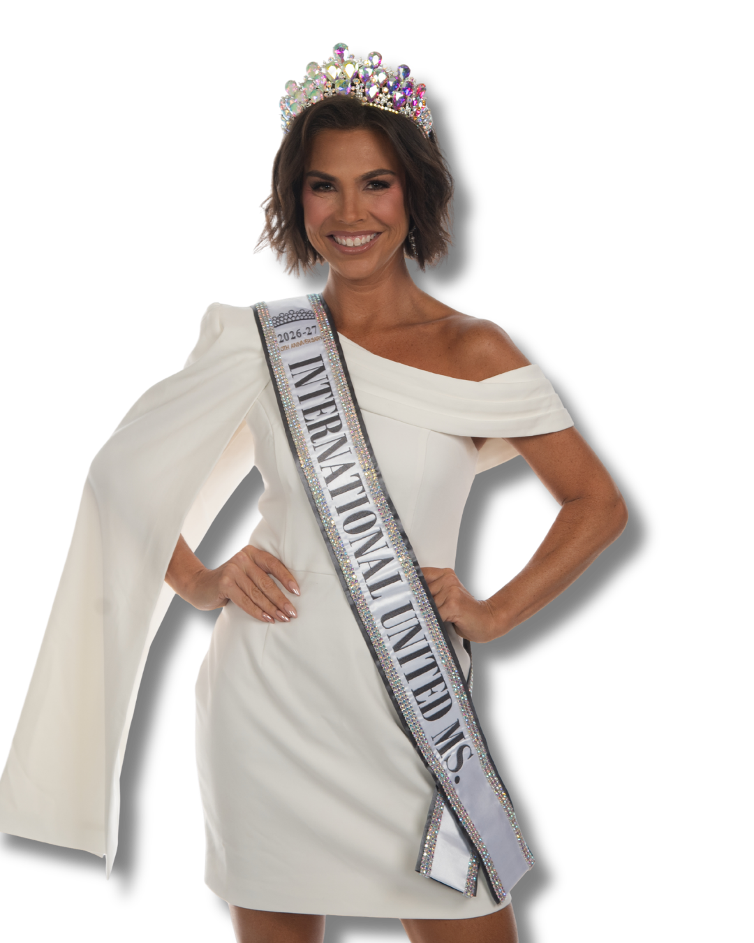 A woman wearing a purple gown, crown, and sash that reads '2025-26 INTERNATIONAL UNITED MS.' smiling with her hands on her hips.