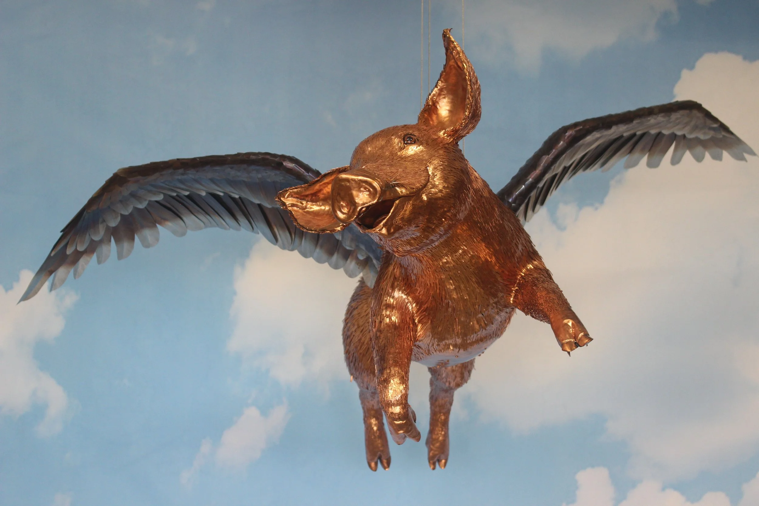 Front view of the copper flying pig sculpture
