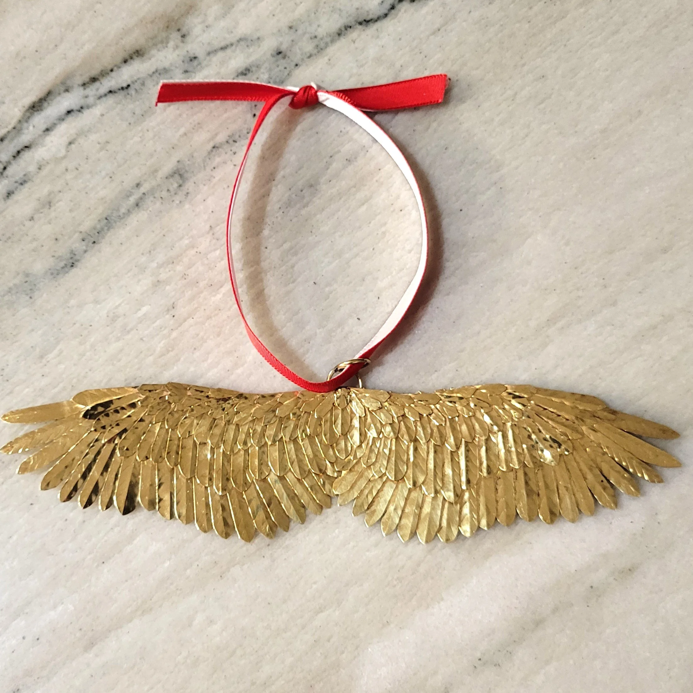 Handmade 2023 brass Christmas ornament on counter-full picture.