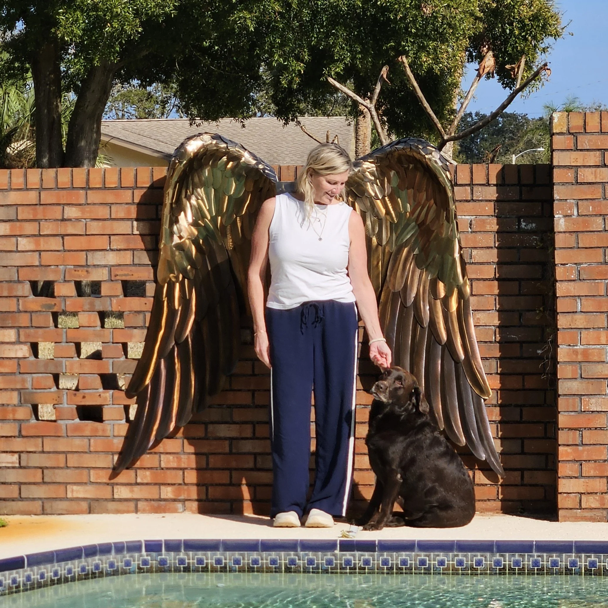 Photo op large angels wings woman petting dog.jpg