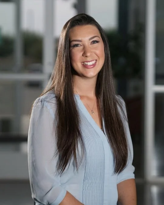 Julie Hartman, Early Childhood Coordinator, smiling in a studio portrait wearing a light blue blouse.